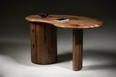 Kidney shaped desk with pebble edge top in European walnut by Jonathan Field