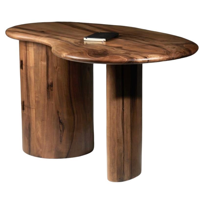 Kidney shaped desk with pebble edge top in European walnut by Jonathan Field