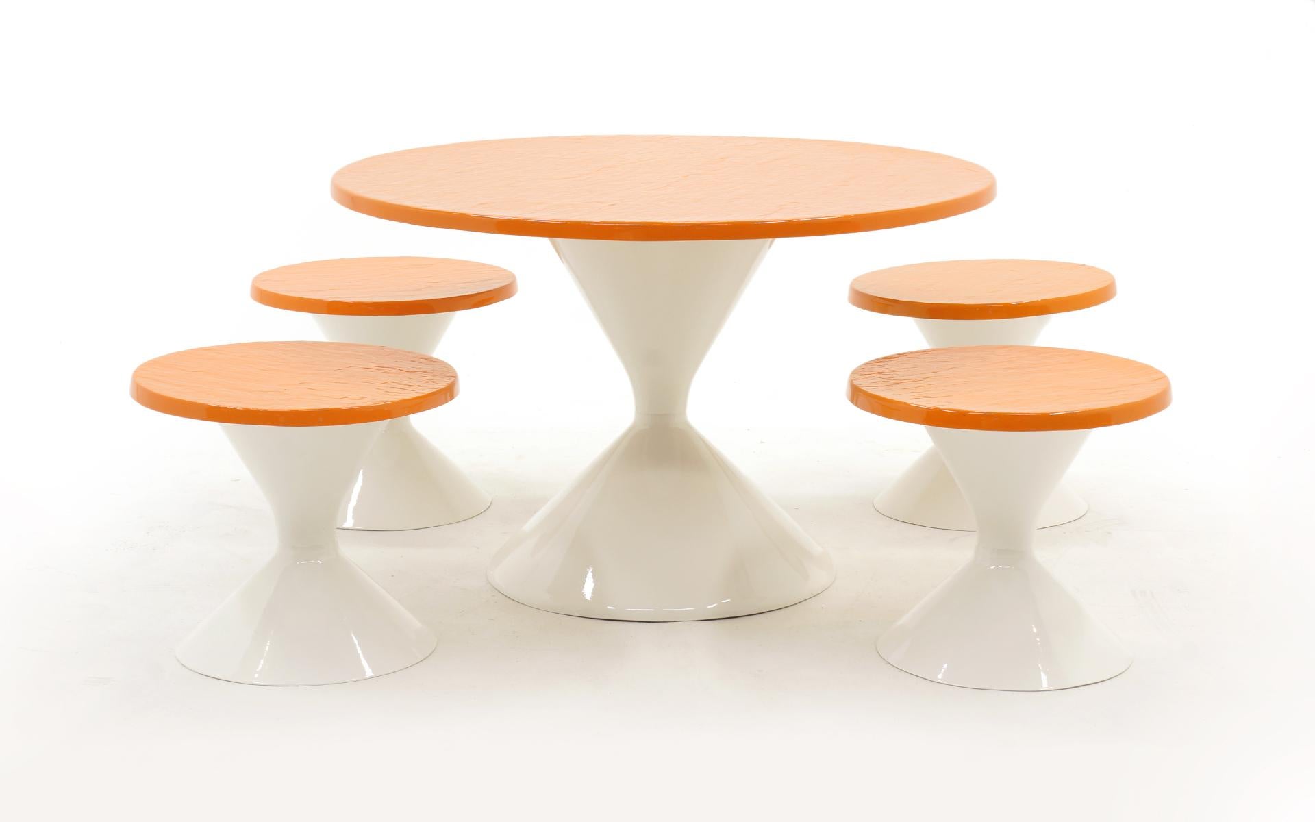 Patio round table and four seats / chairs / stools with white tulip bases and an orange faux slate top. Mod, cool, fun set. Professionally repainted with a white conversion varnish so it will be super durable outside. There are a few imperfections