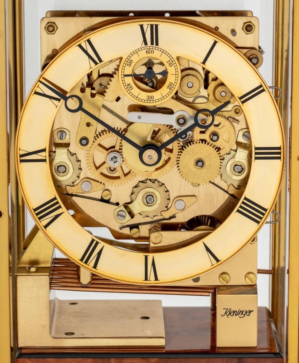 Kieninger Ebonized and Burlwood Table Clock, with four columns, gilt metal hardware, and door opening to clock face marked 