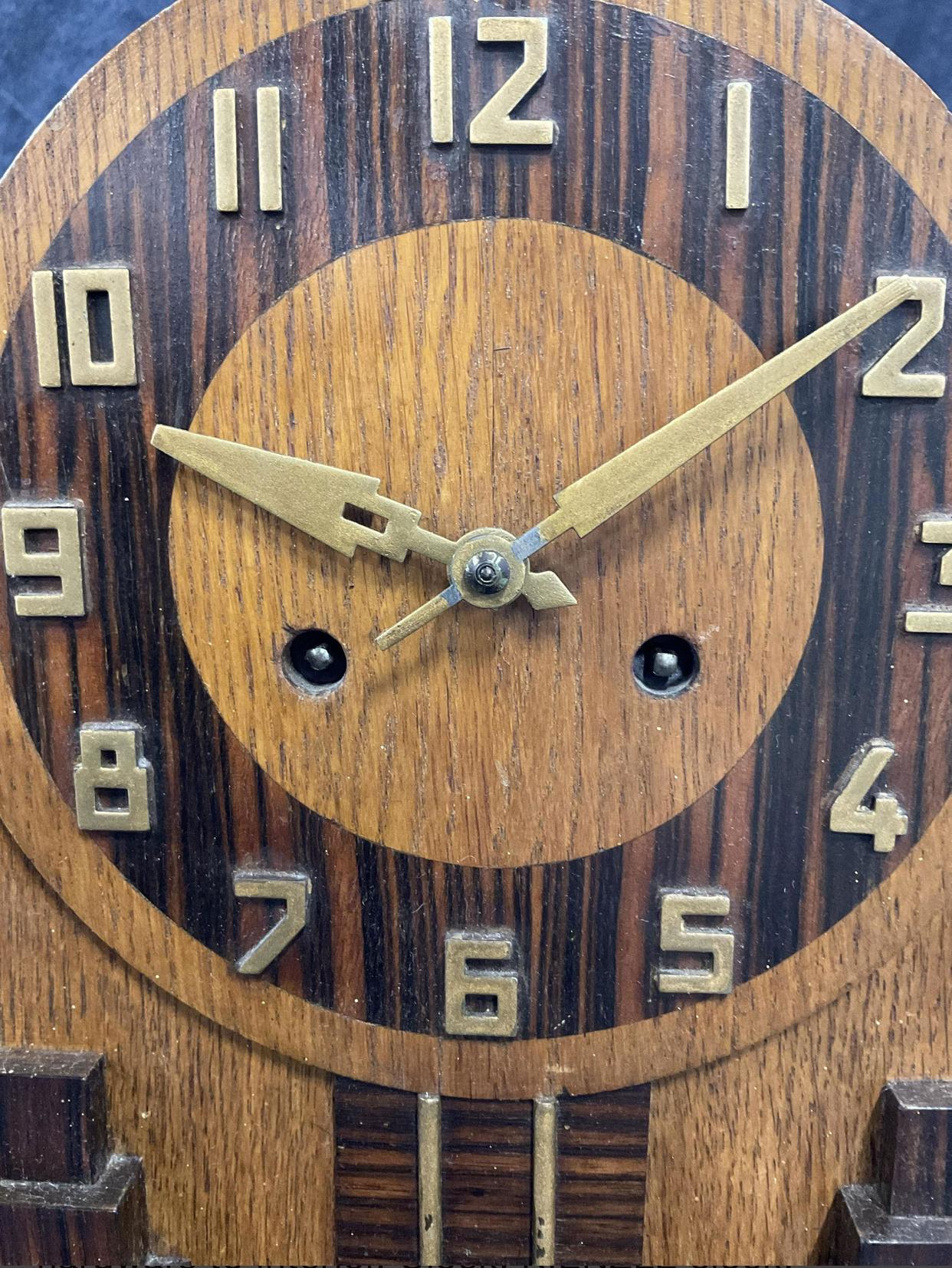 1930s Art Deco mantle clock by Keinzle, one of the top clock manufacturers in Germany during the Art Deco period. Constructed of Macassar Ebony or Zebra wood and oak wood with brass pendulum movement. 

Kienzle Clock History. Kienzle is founded in