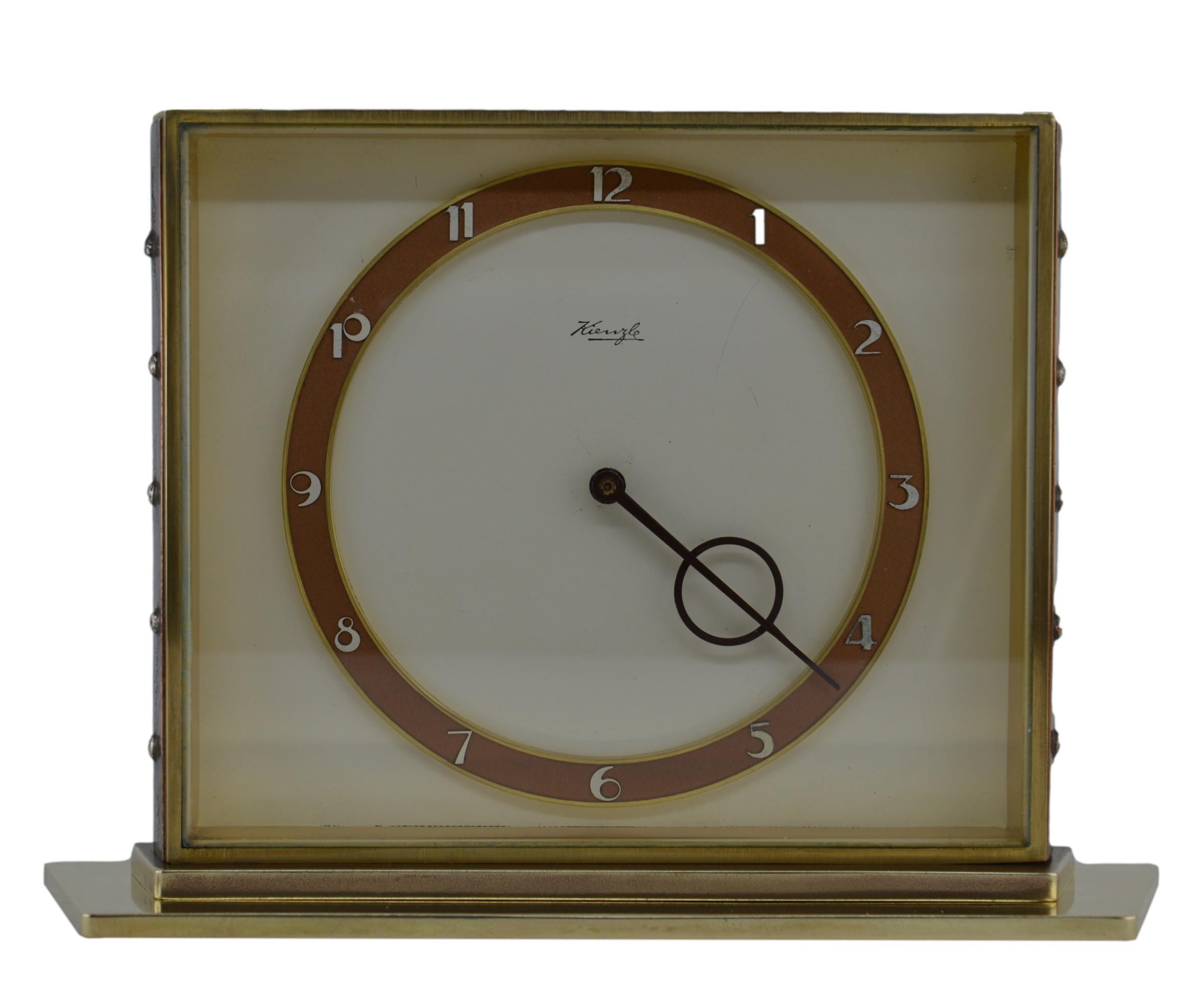German midcentury table clock by Kienzle, Germany, 1950s. Brass and glass. Beveled front glass. 8 days movement. Measures: Height 5.1