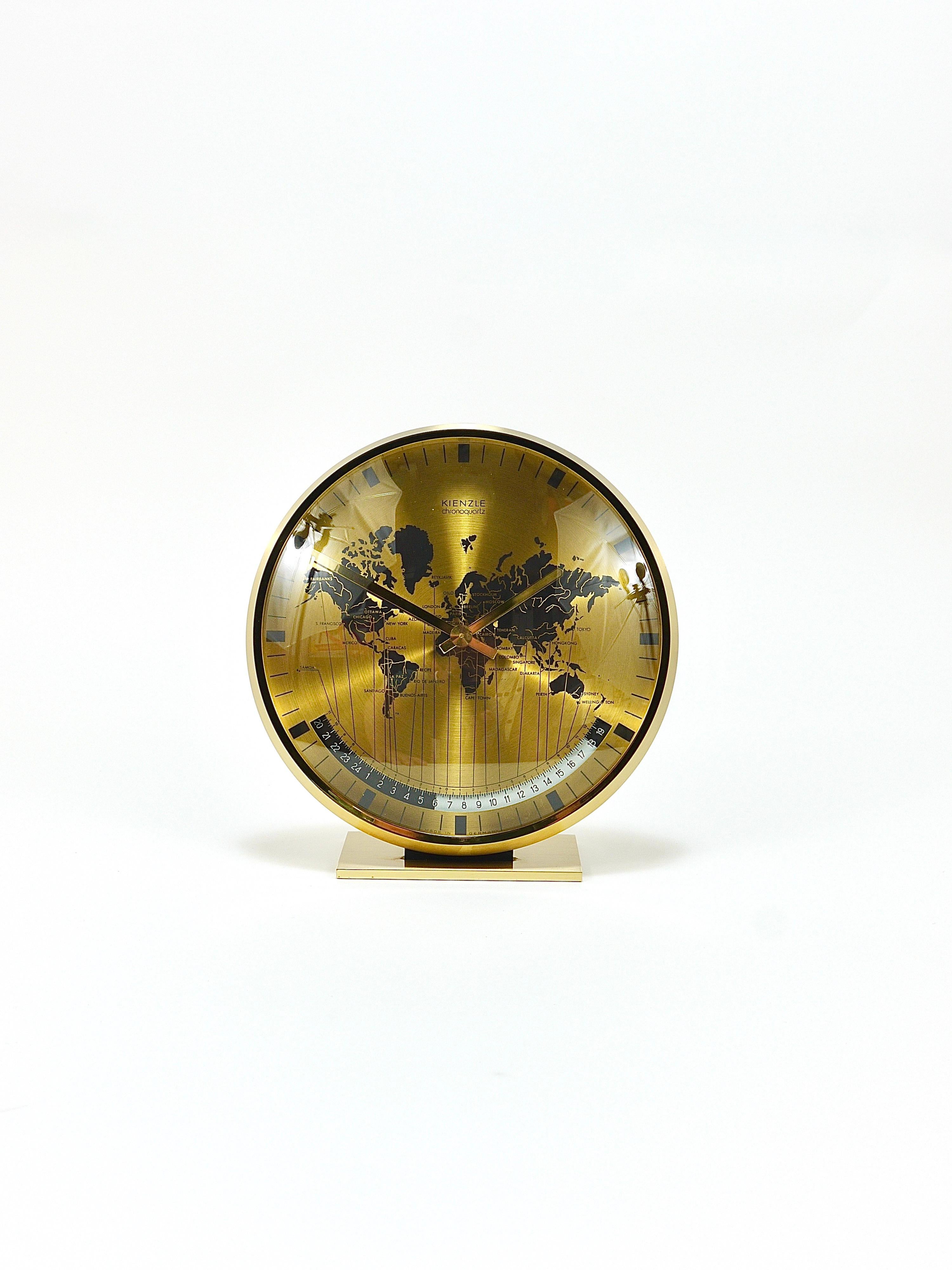 A beautiful and decorative Mid-Century Modernist solid brass Kienzle Chronoquartz desk or table clock with a domed glass and a 7“ diameter world map clocks face and world time zones. Executed in the 1960s by Kienzle in Western Germany. The housing