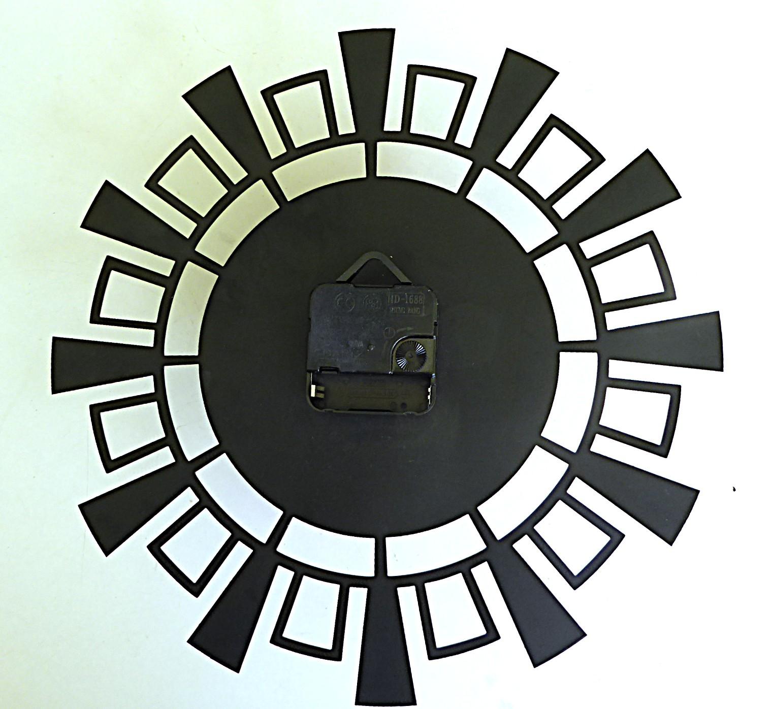    This Kienzel wall clock with a Space Modern design was produced in the early 1960s. Its black thin metal body with the hour numbers in gold paint has one of the iconic shapes of the 1950s-60s.  It is in very good condition considering its age