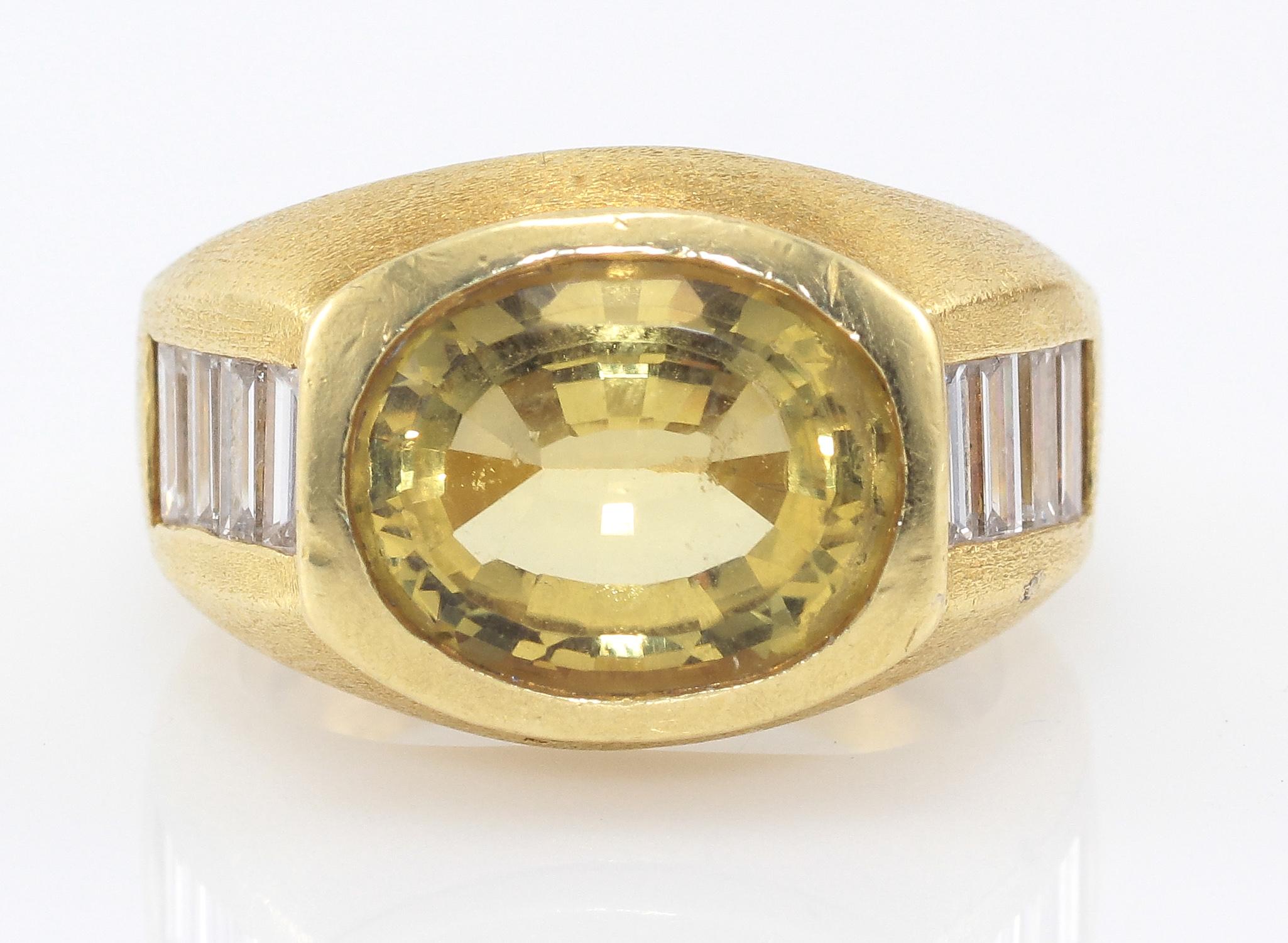This is a very special 18K Yellow Gold Kieselstein-Cord Chrysoberyl and Diamond Baguette Ring. The Oval Chrysoberyl is approximately 4 ct. and has (8) Diamond Baguettes of aproximately 1.15ctw with F-G Color and VS Clarity along the sides. A