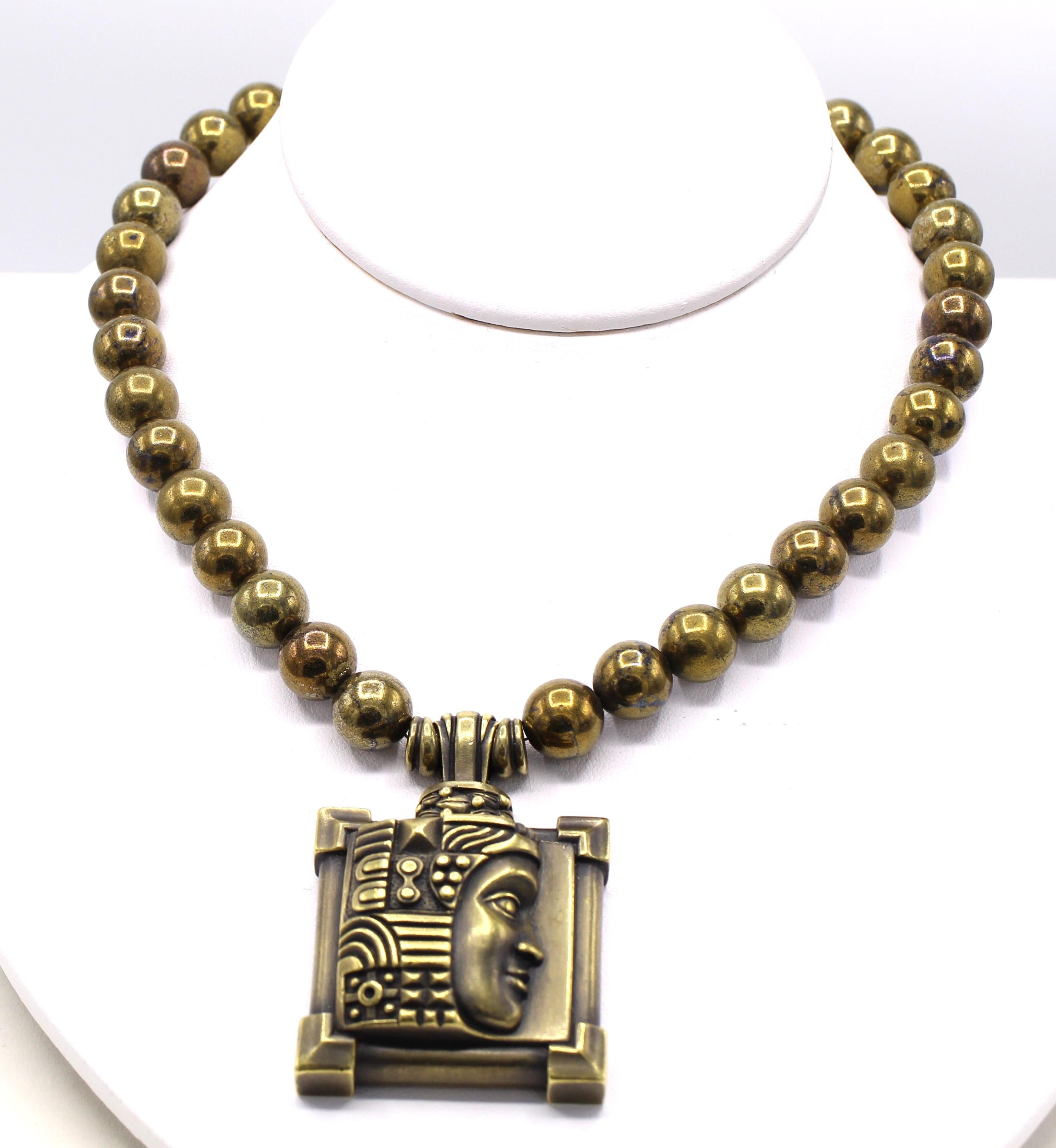 Iconic American designer and jeweler Barry Kieselstein-Cord was well known for his extravagant designs, motifs and unique coloration of gold. In this unique pendant necklace the center pieces is a square element with steps and frames at each corner,