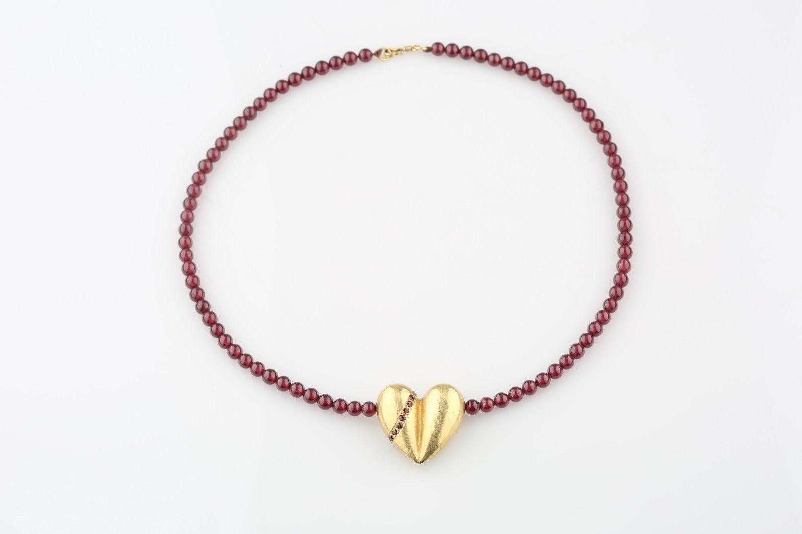 Kieselstein-Cord 18k gold heart pendant
9 rubies appear on one side of the heart, 8 sapphires appear on the opposite
Garnet bead strand necklace with a gold hook and loop
This item is no longer being manufactured, expected production date is late