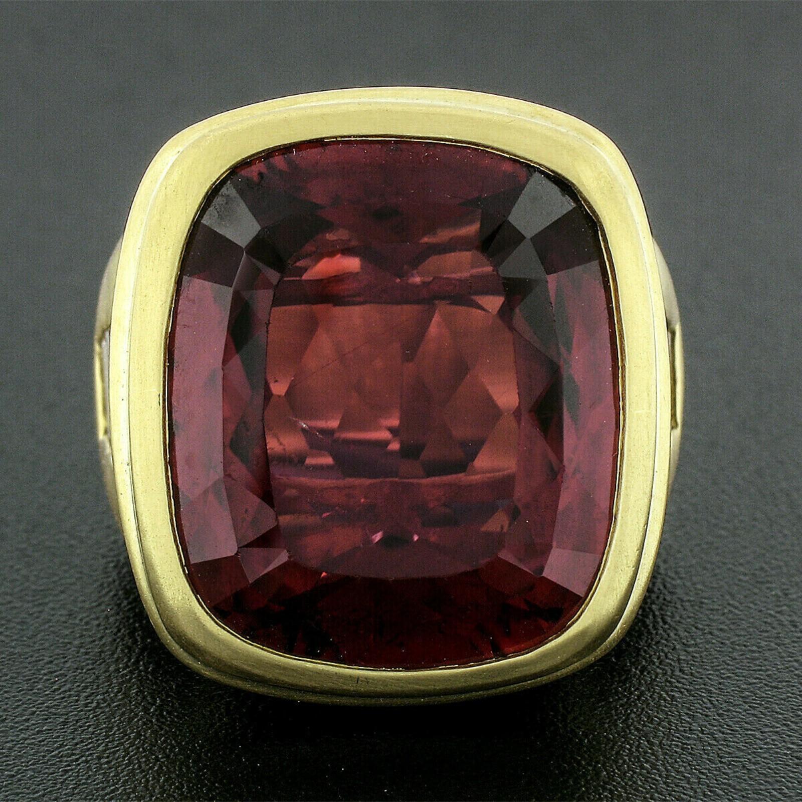 Here we have a magnificent statement ring crafted in solid 18k greenish yellow gold and designed by Kieselsein Cord. The ring features a large and breathtakingly rubellite solitaire, perfectly bezel set at its center. The gorgeous tourmaline weighs