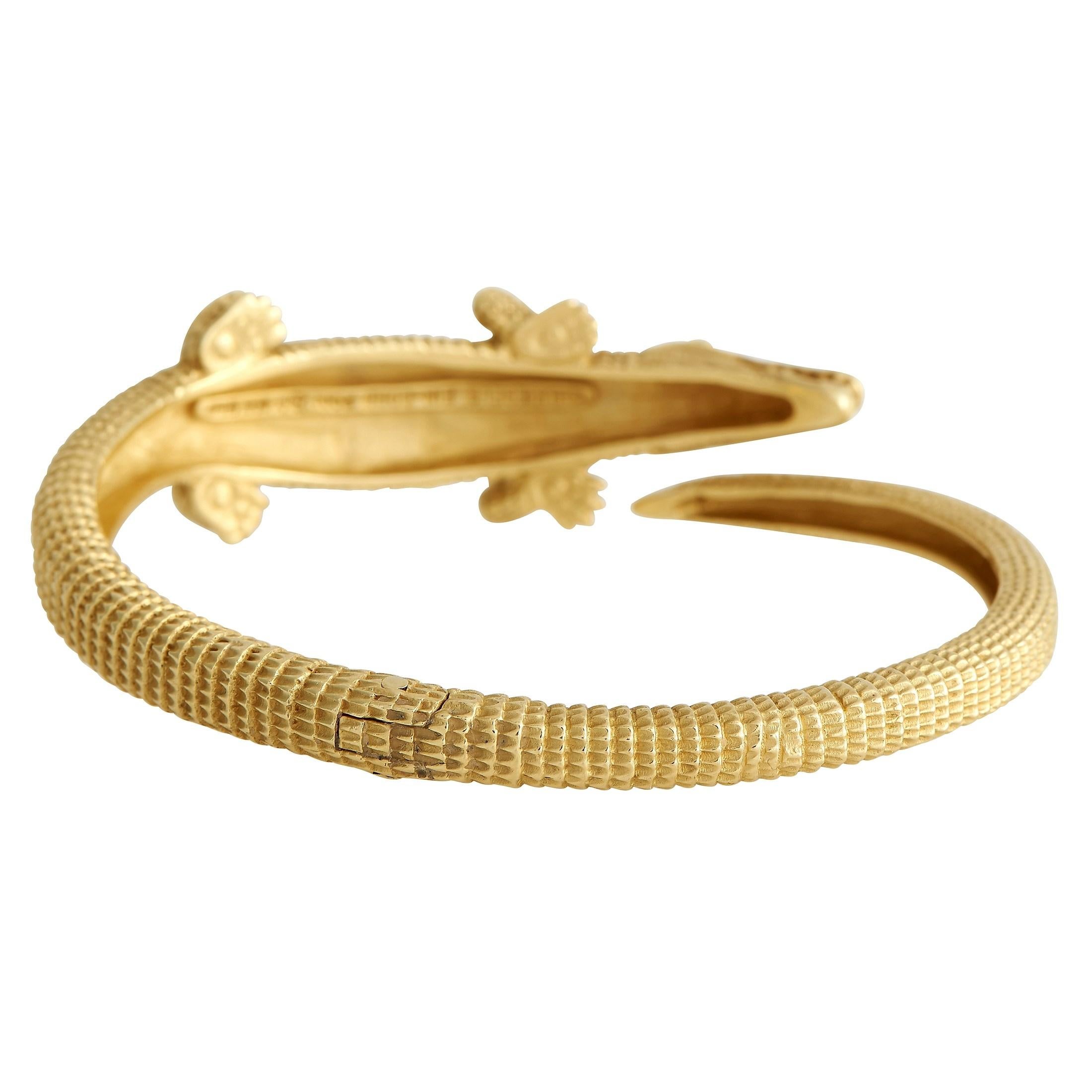 Indulge your wild side and wear this Kieselstein-Cord 18K Yellow Gold Alligator Bracelet loud and proud. This solid 18K yellow gold-hinged bangle measures 7.5 inches long and features a carved and sculpted alligator design. Made by an award-winning