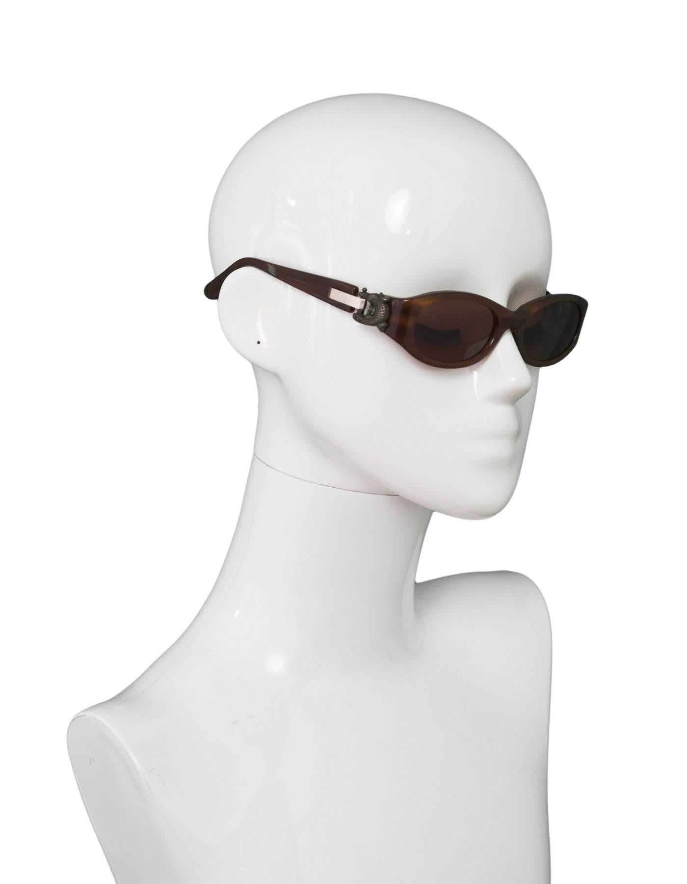 Kieselstein-Cord Brown Surrender Sunglasses
Features alligator detail at arms

Made In: Japan
Color: Brown
Materials: Resin, metal
Overall Condition: Very good pre-owned condition, some tarnishing at hardware, marks and wear at resin
Included: