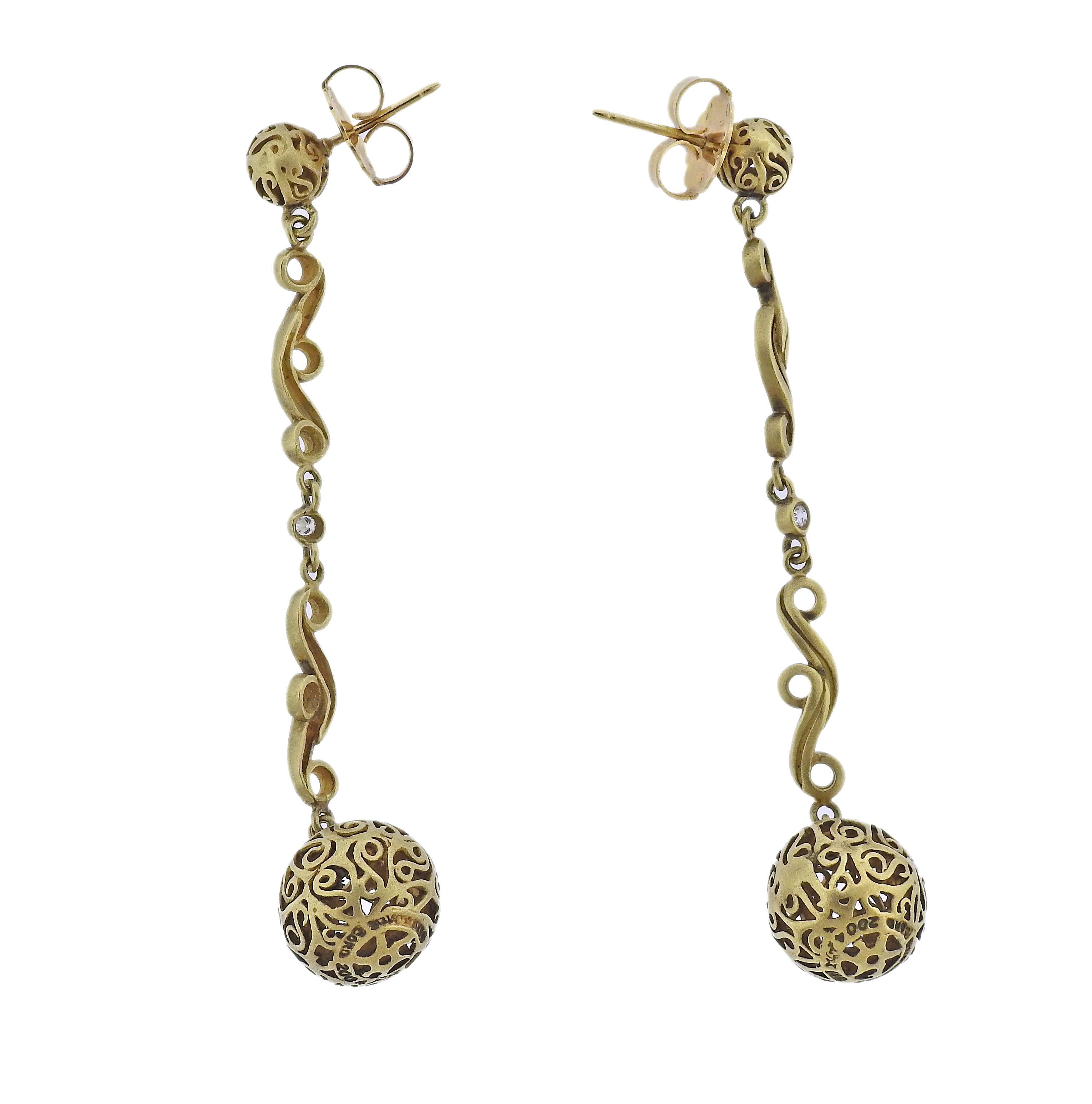 Circa 2004, pair of long 18k gold ball drop earrings by Kieselstein Cord, with approx. 0.10ctw H/VS diamonds. Earrings are 3