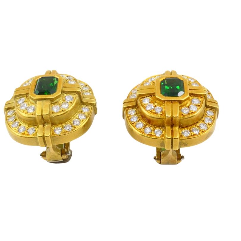 A pair of dazzling Barry Kieselstein-Cord earrings made of 18k gold, featuring green tourmaline and diamonds. 
The gold framework creates a grid-like effect, centering around a rich green tourmaline in an emerald cut. Surrounding the center stone, a