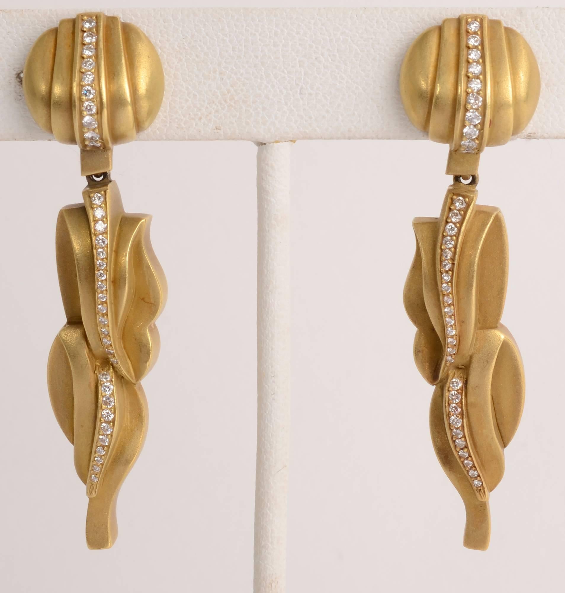 Sophisticated and elegant dangle earrings by Barry Kieselstein Cord. They 18 karat gold has his signature matte finish. 
A row of diamonds goes top to bottom in these very sculptural and dramatic ear clips. They are dated 1983.
Clip backs can be