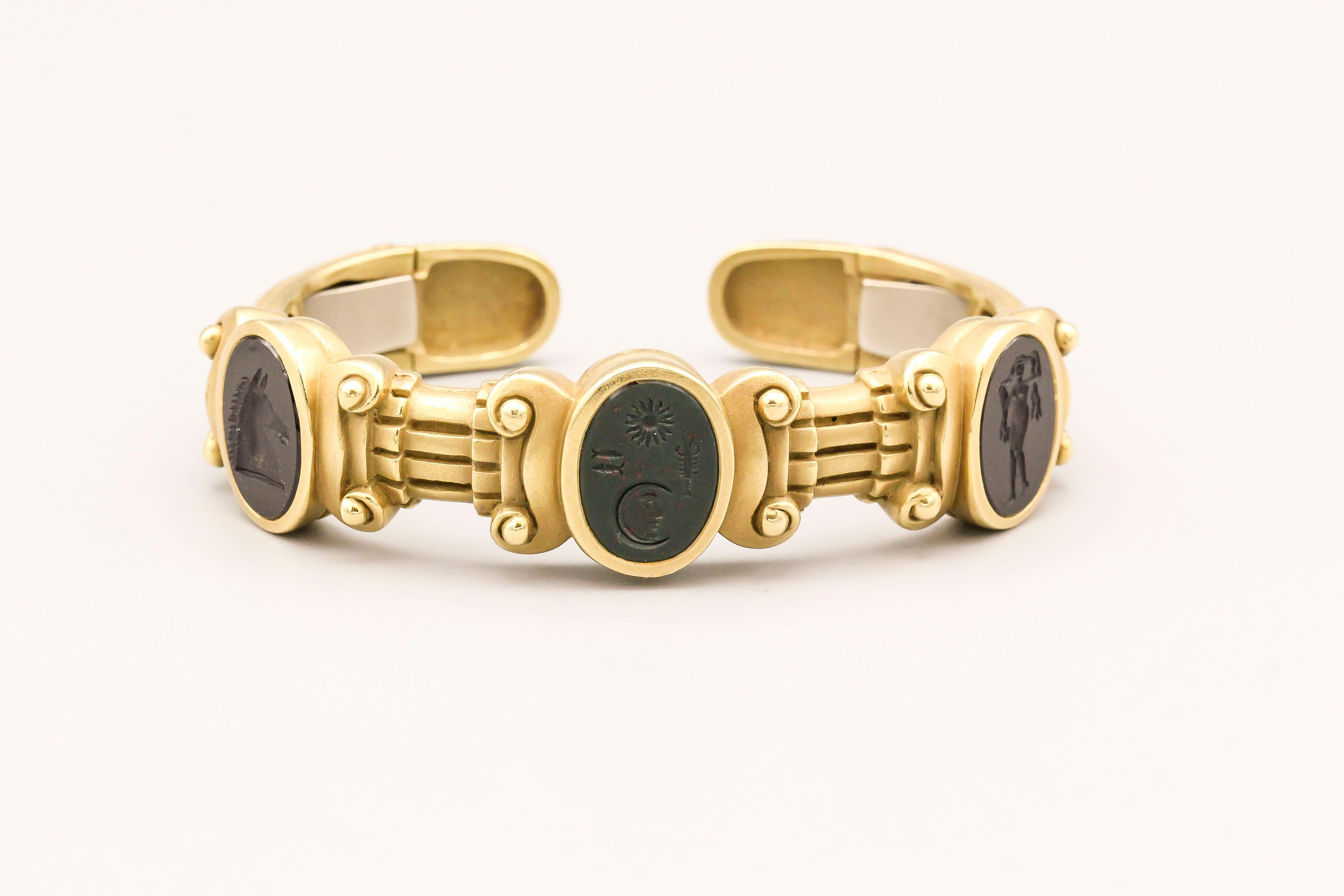 Fine 18k gold cuff bracelet by Kieselstein-Cord.  This bracelet features 3 intaglios of varying designs: bust of a horse, a nude, and the signature sun/moon intaglio with fish and lobster.  Total weight a substantial 78.7 grams, will fit a wrist