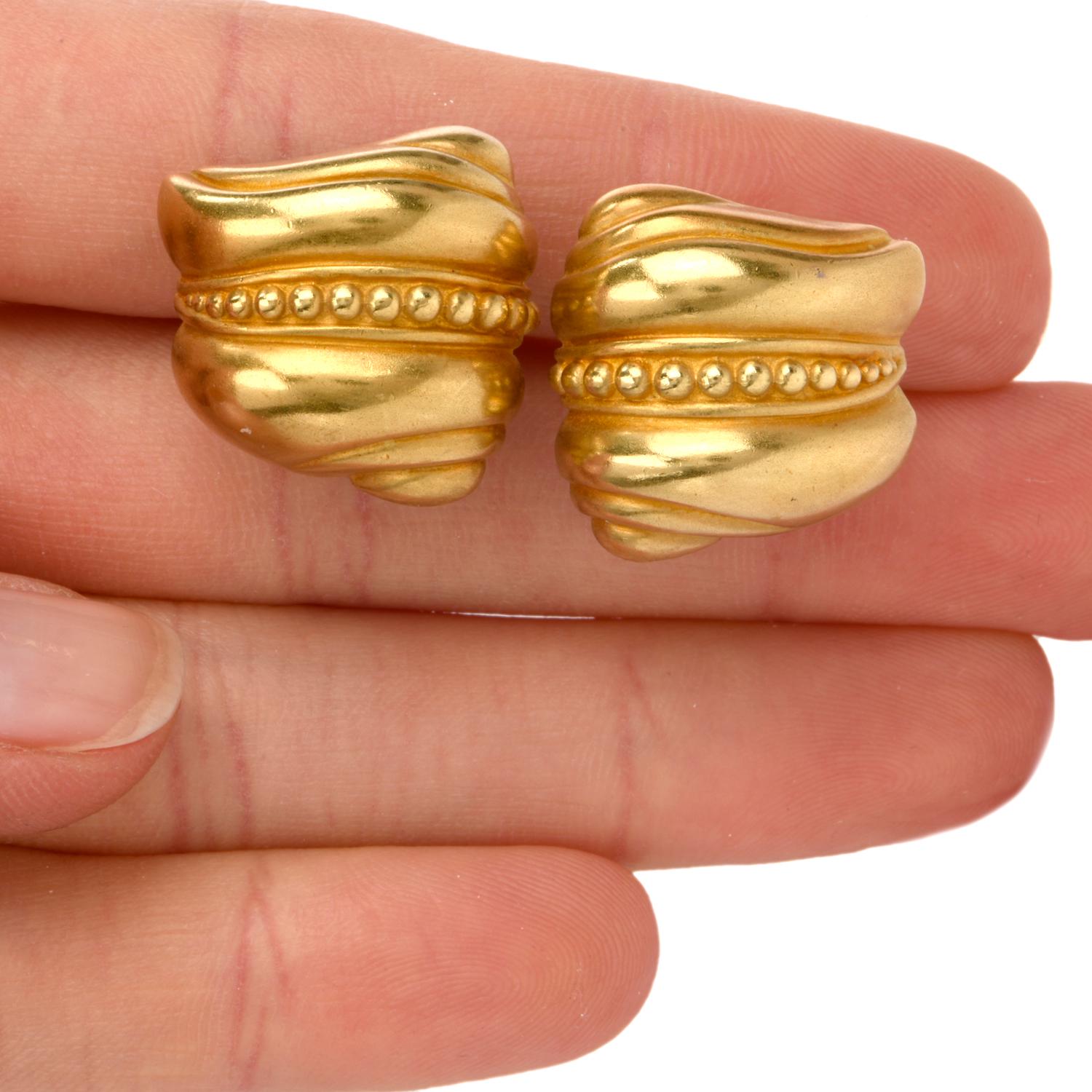 These classic Barry Kieselstein-Cord's designer shell and 'caviar' earrings are crafted in 18-karat yellow gold. Circa 1980's, they are designed to simulate swirled shells with a row of spheres in the center. Earrings weigh 18.2 grams and measure