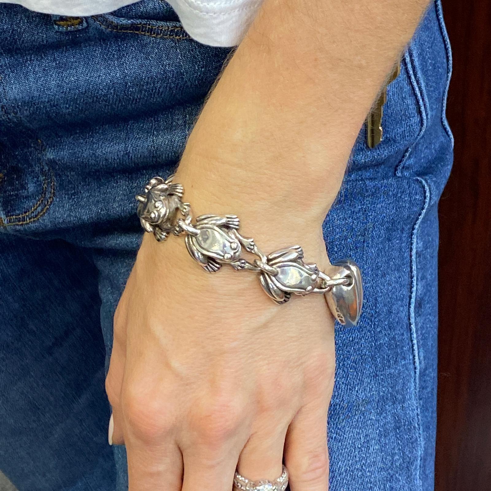 Vintage Kieselstein-Cord frog and heart link bracelet fashioned in sterling silver. Each frog link is signed, and the bracelet measures 8.0 inches in length and 1 inch in width (at the widest part). Signed 1997 925 Kieselstein-Cord. 