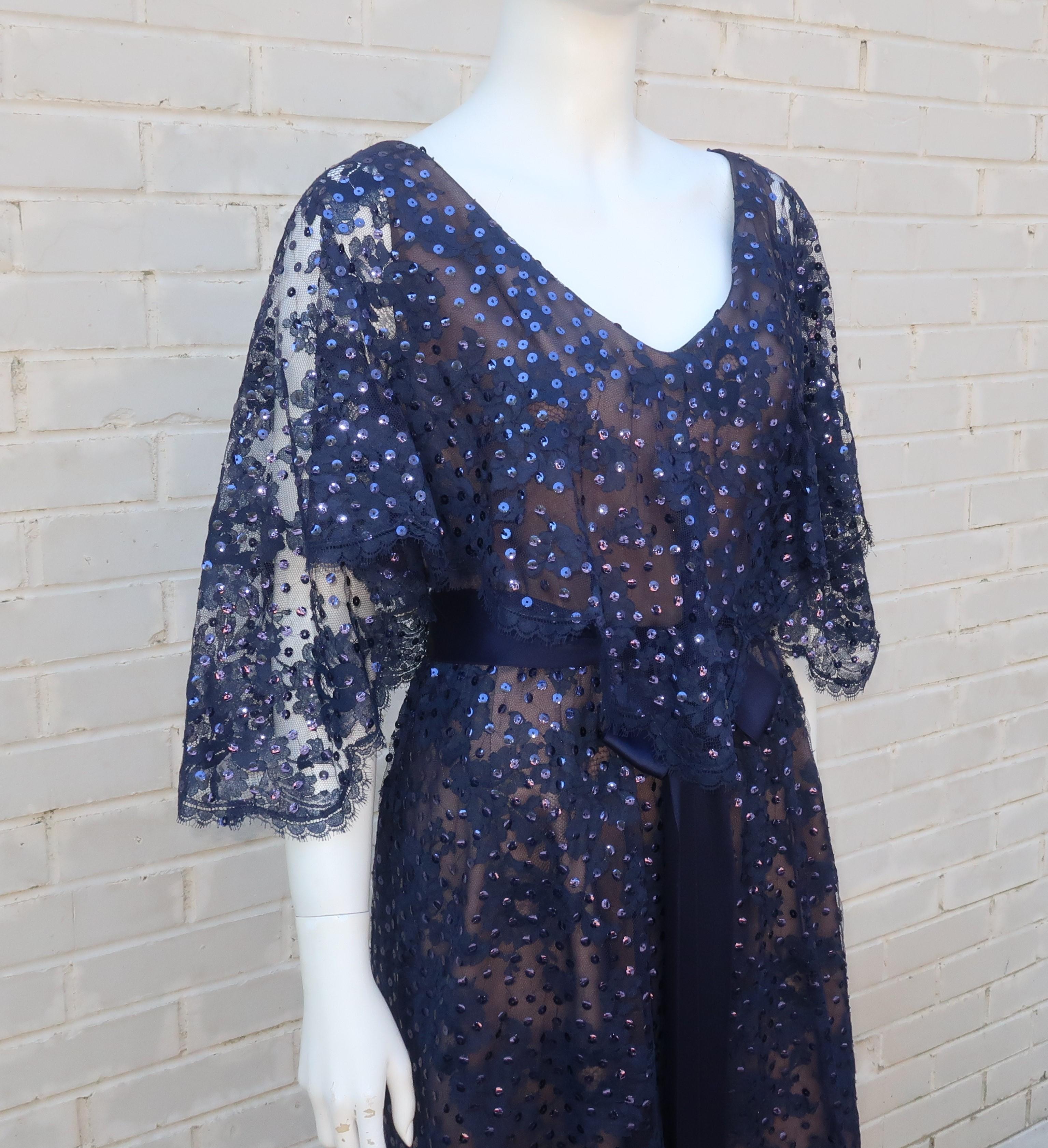Kiki Hart creates a beautiful dark blue lace formal dress with nude illusion panels and sequins for catching the evening light.  Though from the 1960's, the silhouette of the dress pays homage to Edwardian designs with a capelet style overlay at the