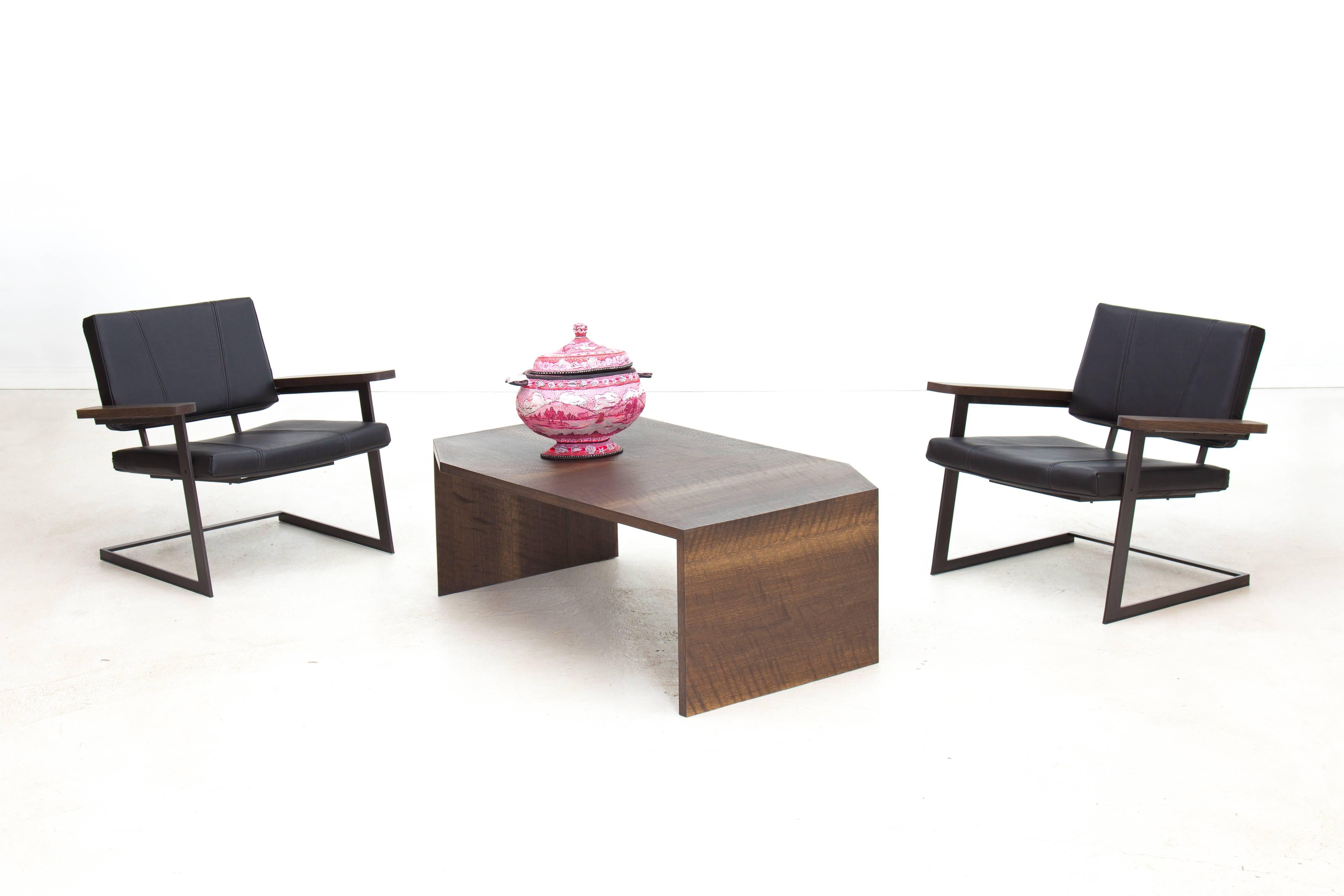 The angles and form of the Kiki Low Table are a nod to Brutalist architecture and minimalist sculpture of the 1960s and 1970s. Shown in patterned ebonized oak and available in a variety of American hardwoods. The Kiki Low Table is made to order, so