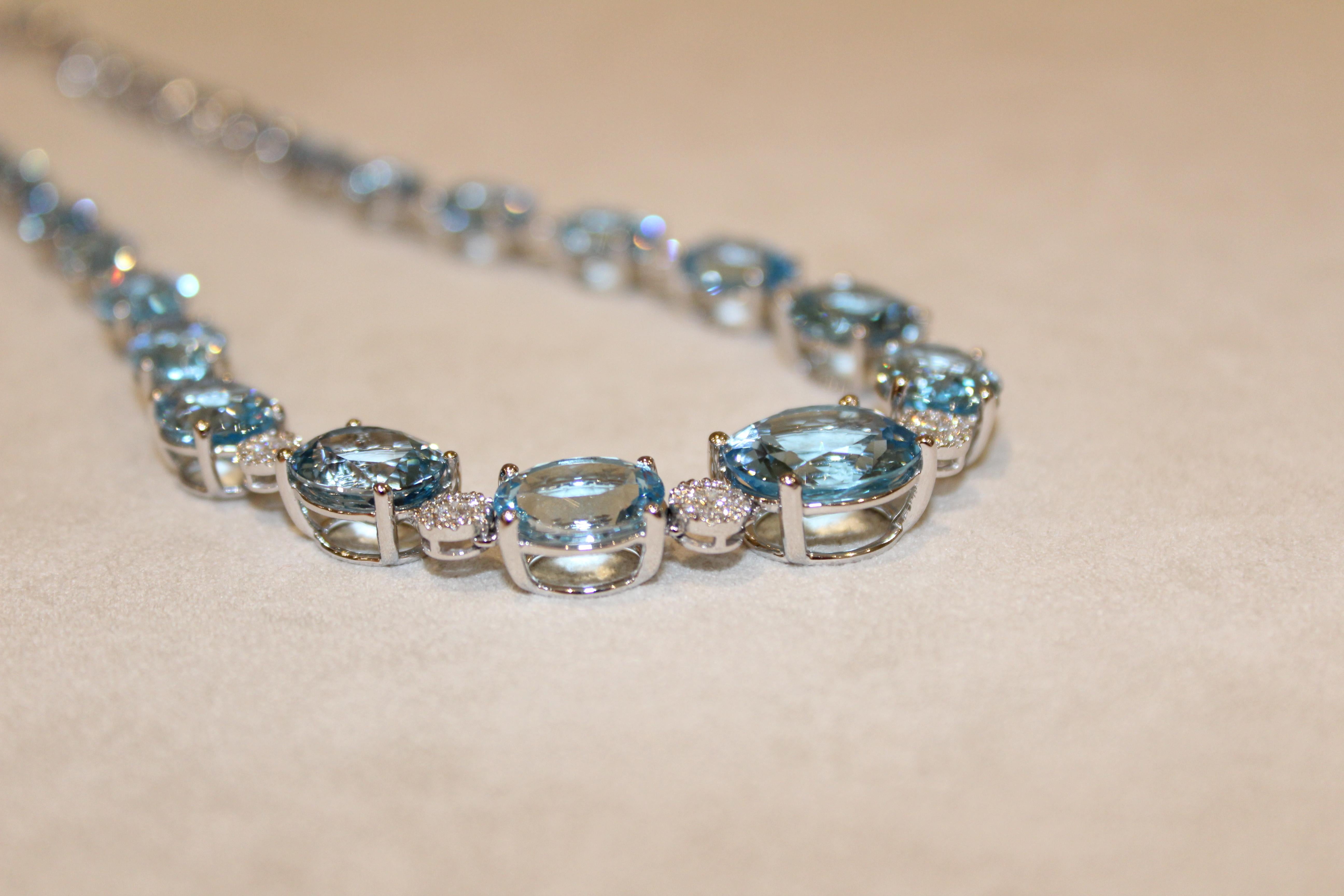 18ct White Gold and Blue Topaz (39.40ct) Necklace with diamond round detail (1.80ct) - perfect for evening wear, this vivd piece is a showstopper. 

	
Necklace dimensions - Small stone 6 x 8mm, Medium stone 8 x 10mm, Large stone 9 x 11mm, Full