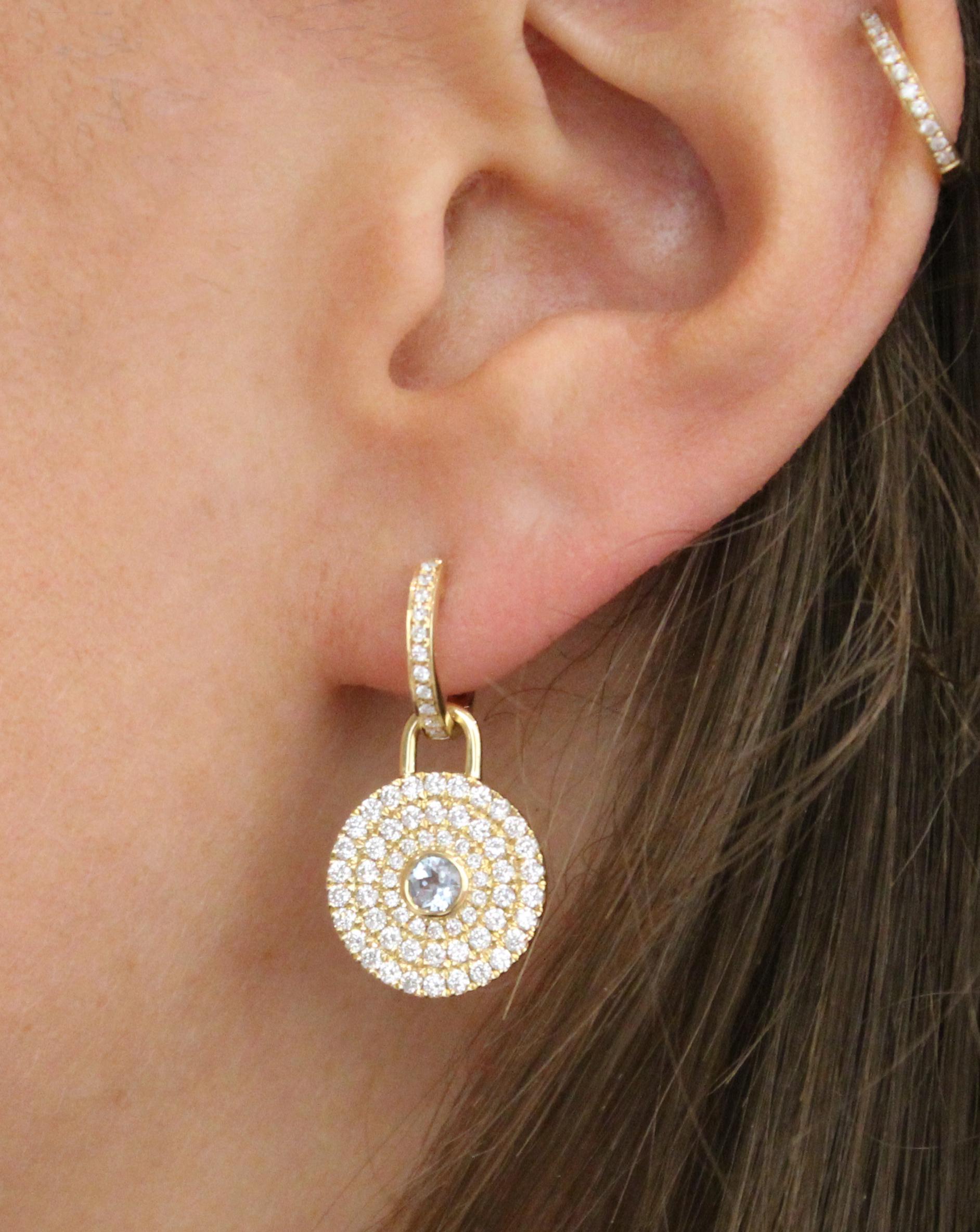 This beautiful pair of earrings consist of two parts: An extremely versatile 18ct Yellow Gold Diamond hoop and a detachable drop featuring a central Blue Topaz (0.37ct) stone, surrounded by Diamond (1.22ct) halos. This enables you to mix and match