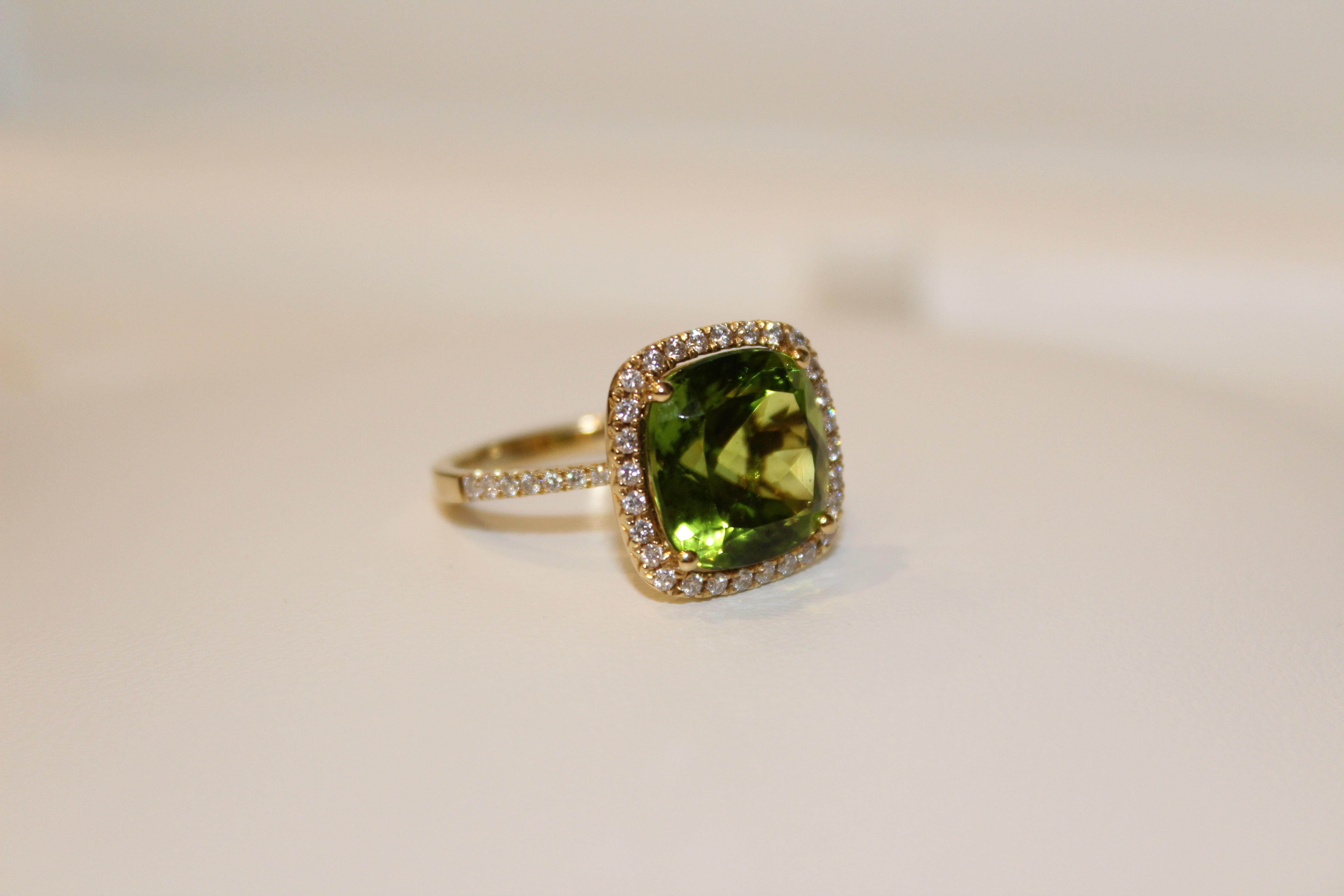This showstopper is vibrant and fun to wear. The central stone, Peridot (8.37cts), is a beautiful deep Green colour that matches every skintone. It is surrounded by a halo of sparkling Diamonds (0.42cts) that also travel halfway around the