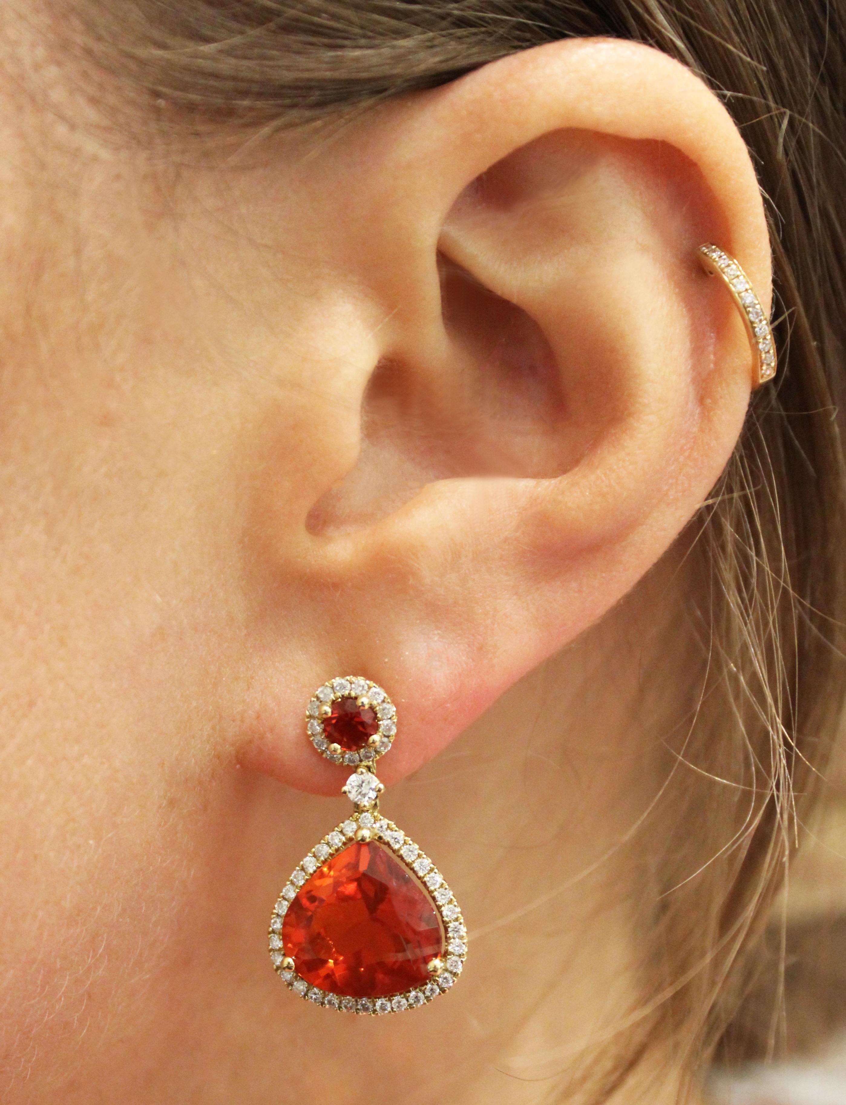 Designed in 2017 by Kiki McDonough this stunning 18ct yellow gold earrings with a large teardrop fire opal (7.70cts) surrounded by diamonds (0.85cts)with a round cut fire opal (0.33cts) top is a perfect example of the Mexican Fire Opal at its very