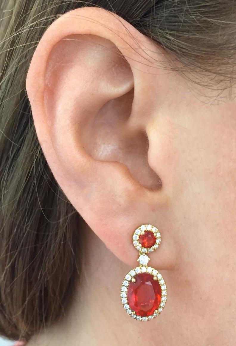 The deep crimson of the stones used in these Special Edition earrings solidifies the reason why these earrings are a one-of-a-kind piece. 

The large oval and round cut Mexican Fire Opals (4.14cts) set in 18ct Yellow Gold with 0.44cts of diamond