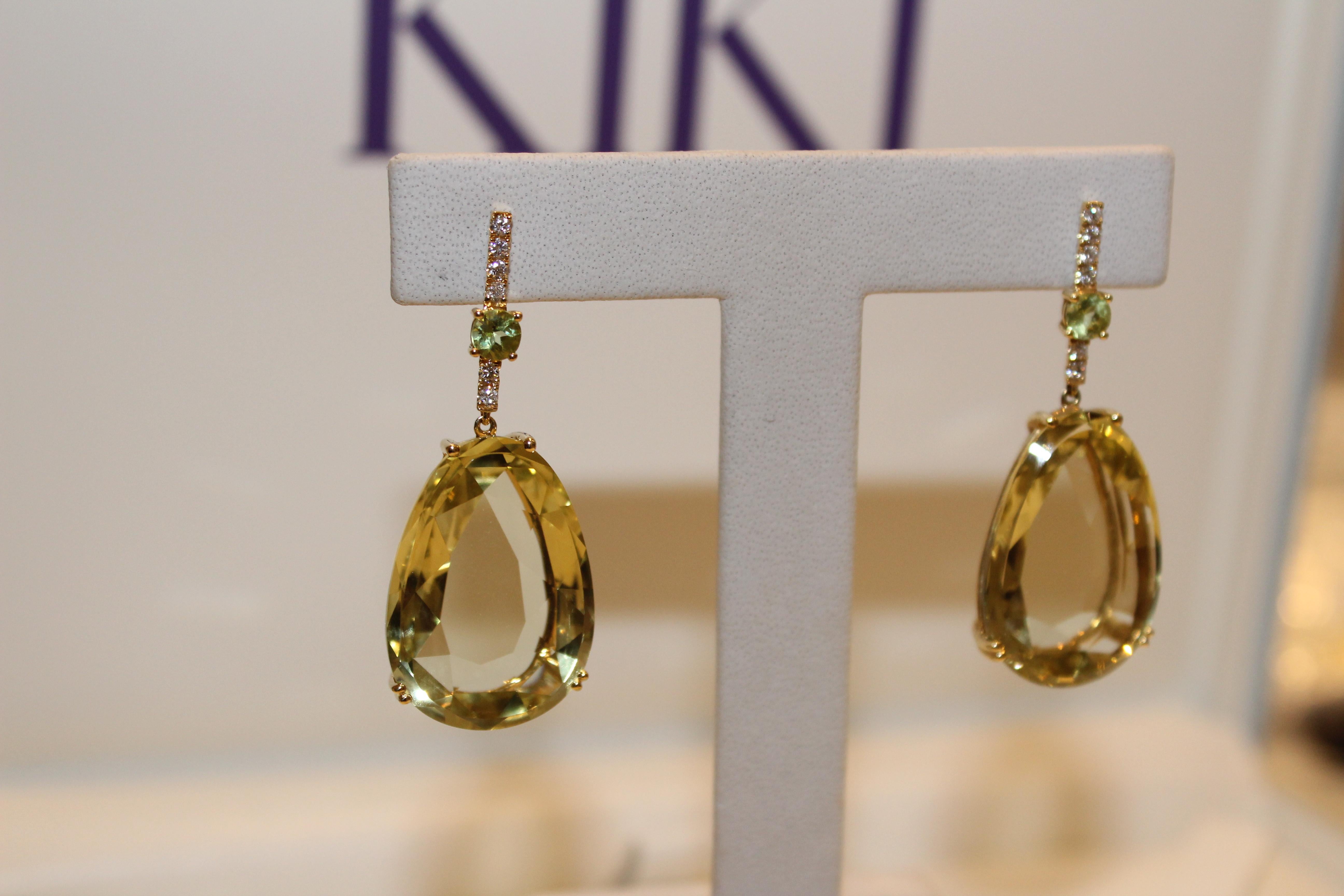 From our colourful candy collection, these stunning earrings feature a central Lemon Quartz stone set in 18ct Yellow Gold that hangs from a pave Diamond post, adorned with a small Peridot stone. 
