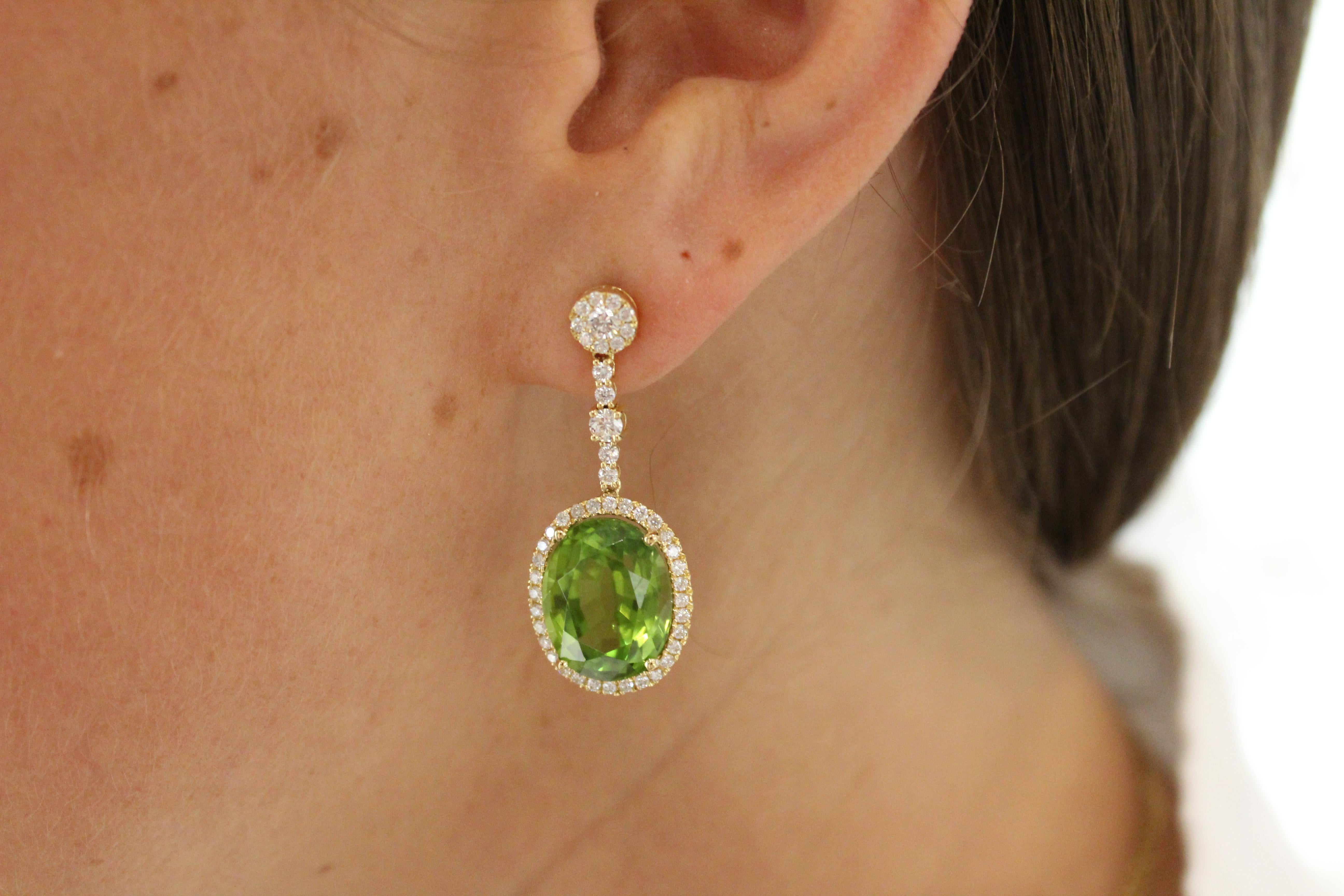 Each earring features a Diamond (1.12cts) stud, with a sparkling Diamond post below. Diamonds then halo a stunning central Peridot (17.89) stone to create a stunning pair of earrings.

Peridot is a universal stone that looks incredible on every