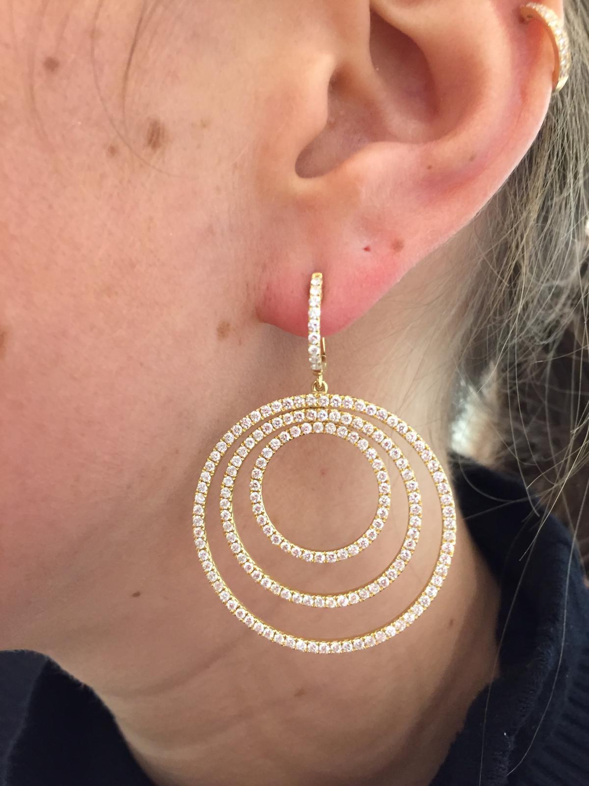 These stunning hoop earrings are for any occasion. Featuring three Pave Diamond (4.00kts) hoops set in 18 karat Yellow Gold, these earrings are a contemporary twist on an 80's style. 