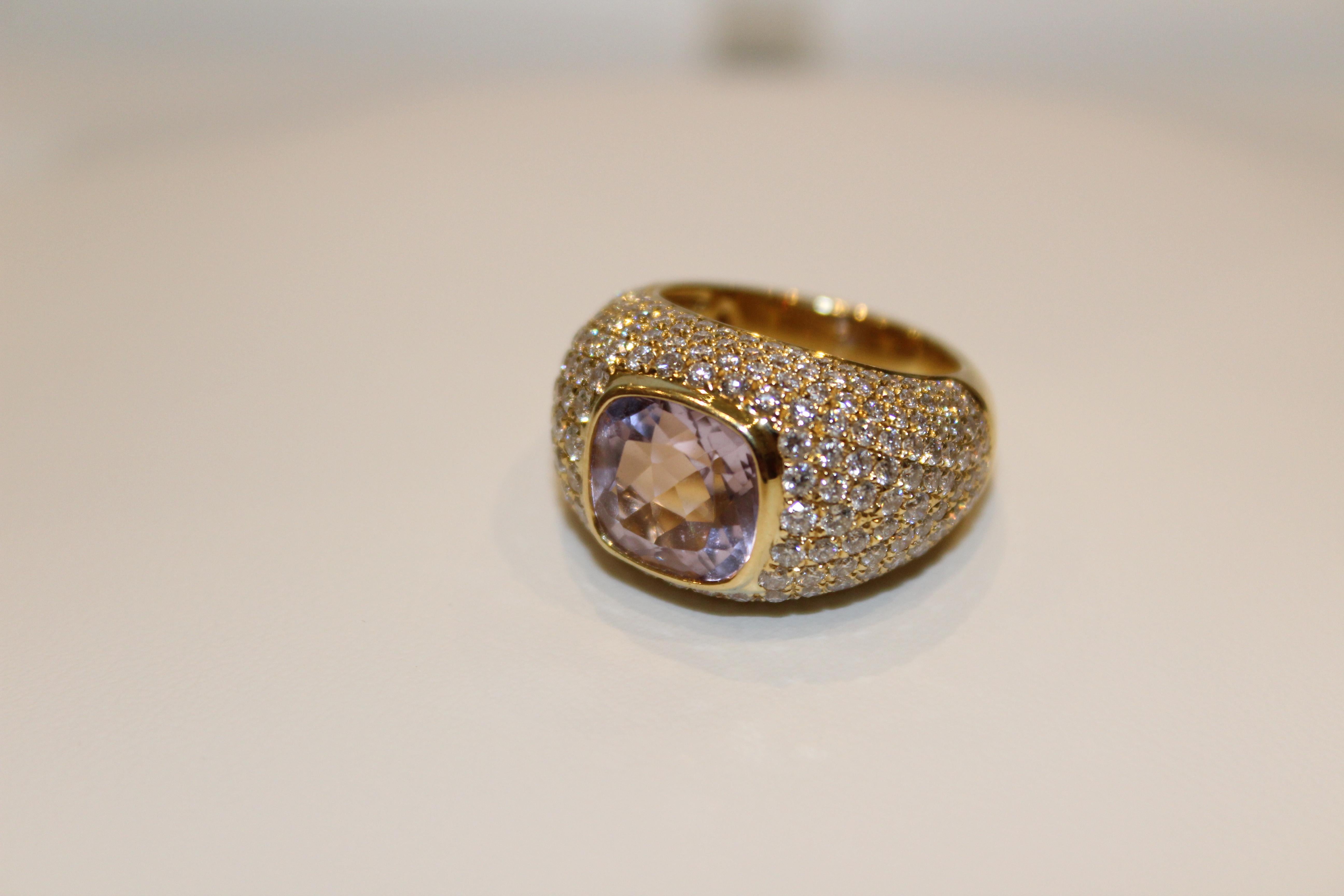 This dazzling statement ring features a central cushion-cut Lavender Amethyst ring set in 18ct Yellow Gold, surrounded by multiple rows of Pave Diamonds. The resulting ring is a statement piece that would look beautiful with an evening gown or as an