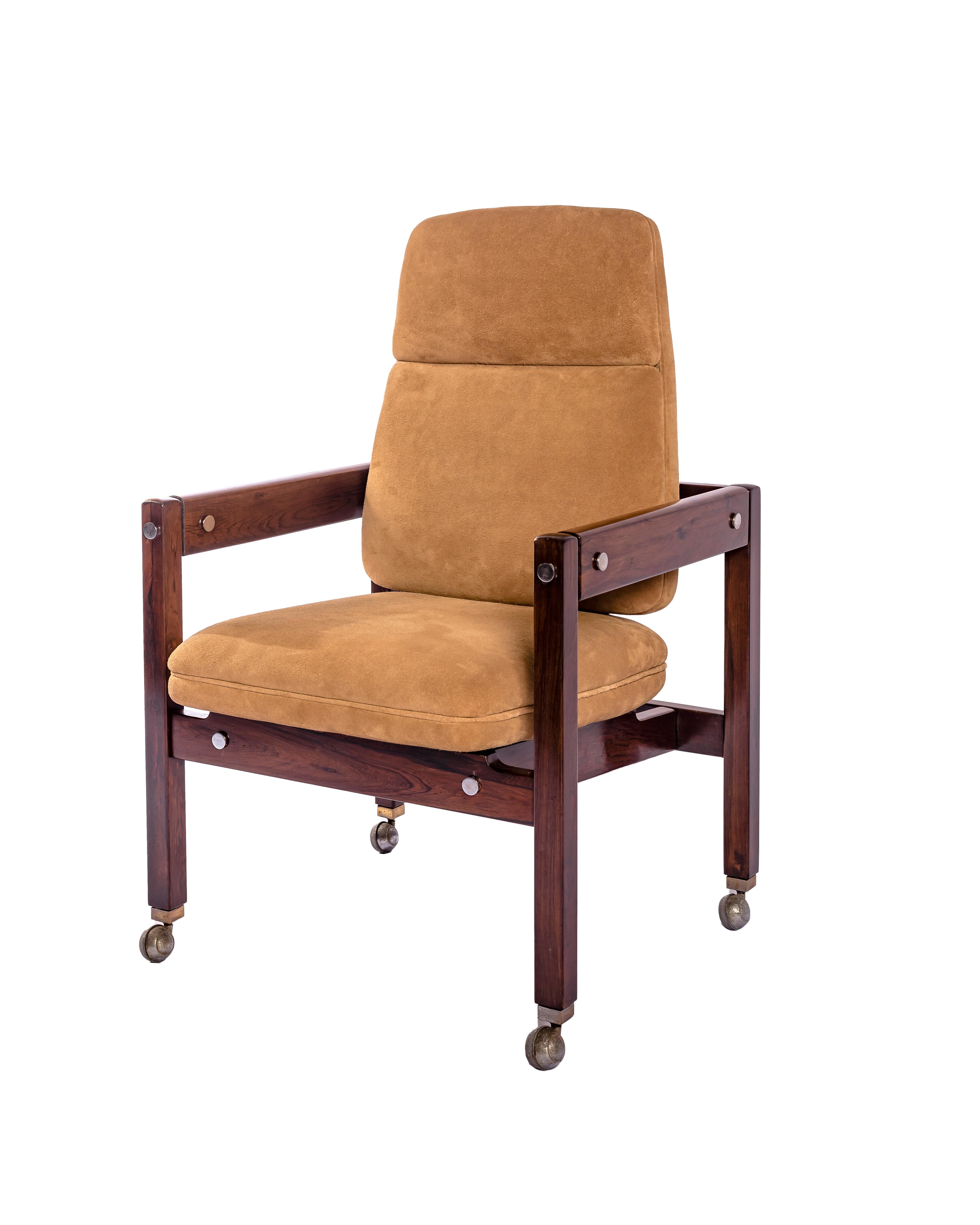 El sillón Kiko, un raro modelo de la producción de Rodrigues de los años 60, combina la calidez del jacarandá brasileño con una sensibilidad industrial expresada a través de sus herrajes metálicos visibles y sus ruedas. La estructura lineal se