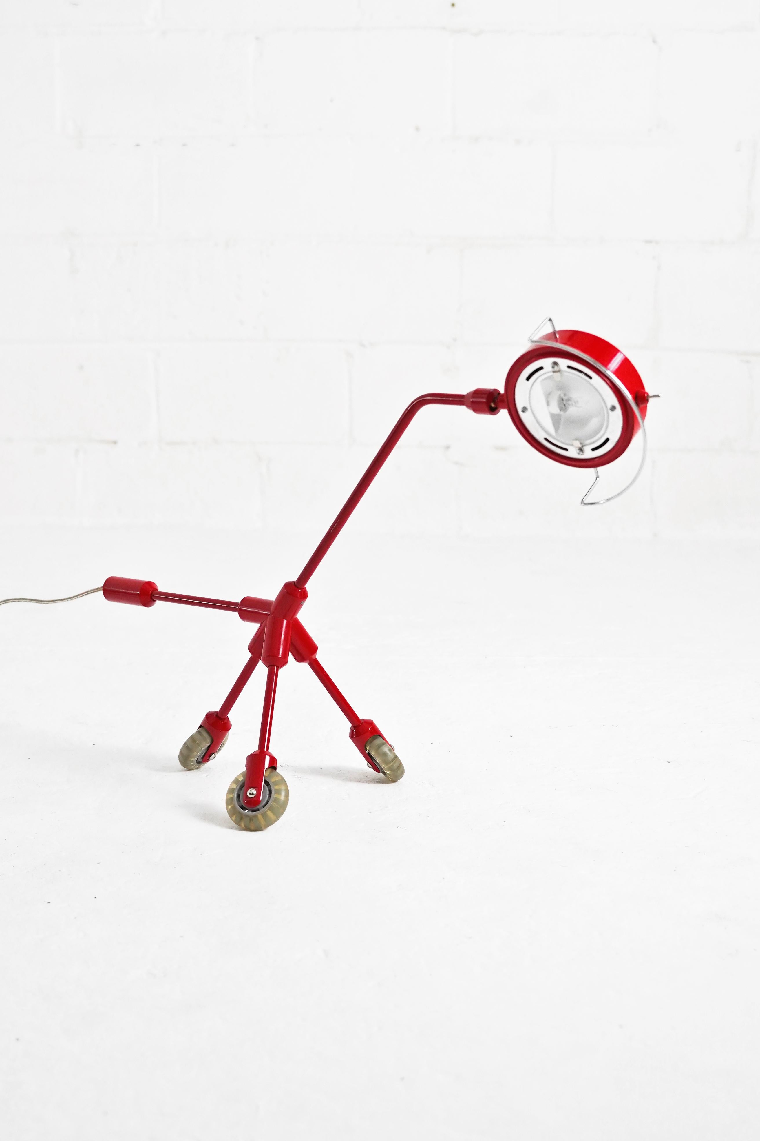 Amazing Kila vibrant red dog rolling table lamp designed by Harry Allen for IKEA. In great vintage condition, working perfectly with American 2-prong plug. Fixture is able to rotate for users needs, shown in photos, as well as roll with tripod base