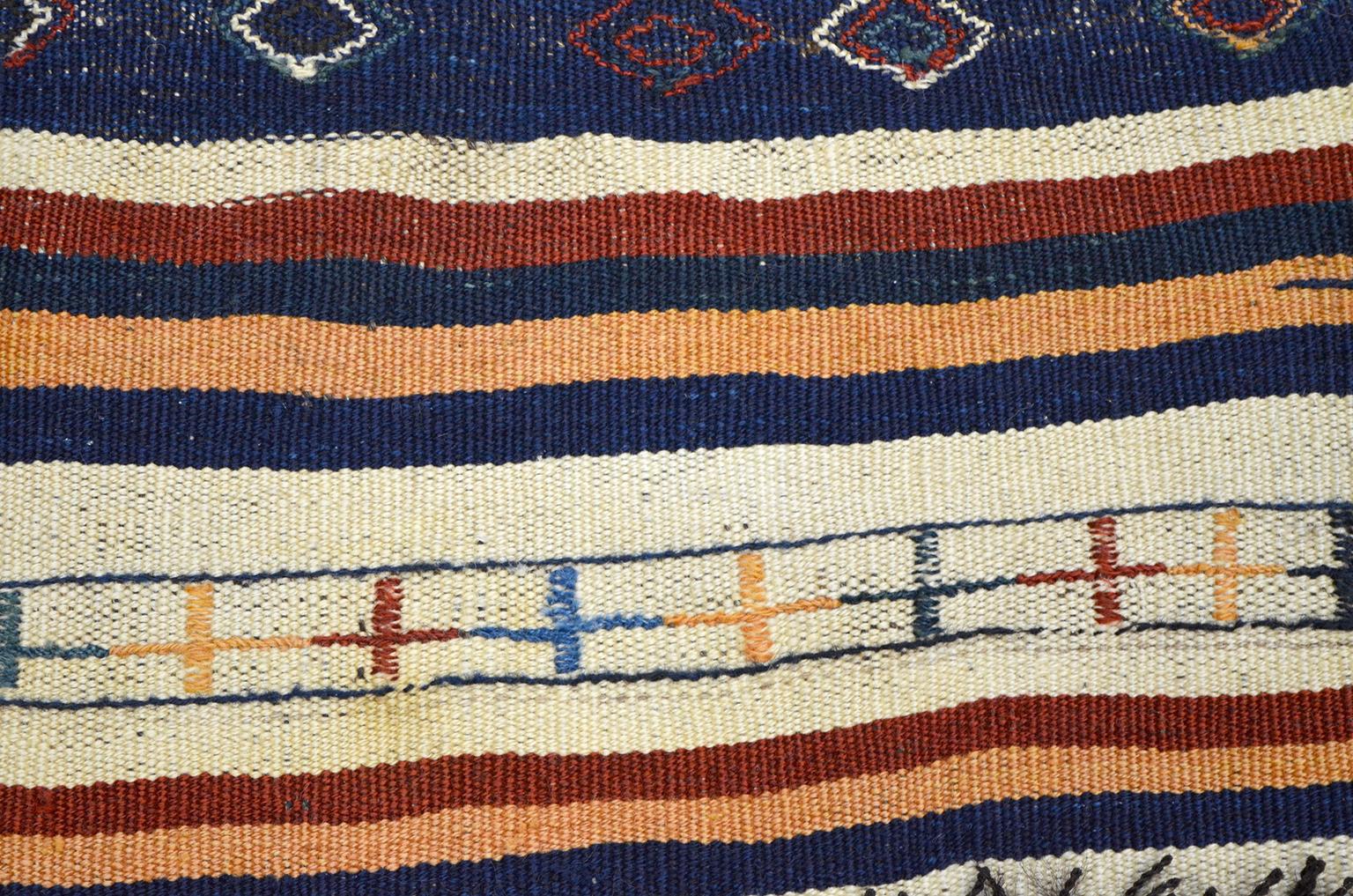 This kilim and soumak Persian saddle blanket in pure wool, circa 1910 exhibits a unique combination of vegetable dyed primary colors amid undyed wools. It is in good antique condition, and the size is 3'4