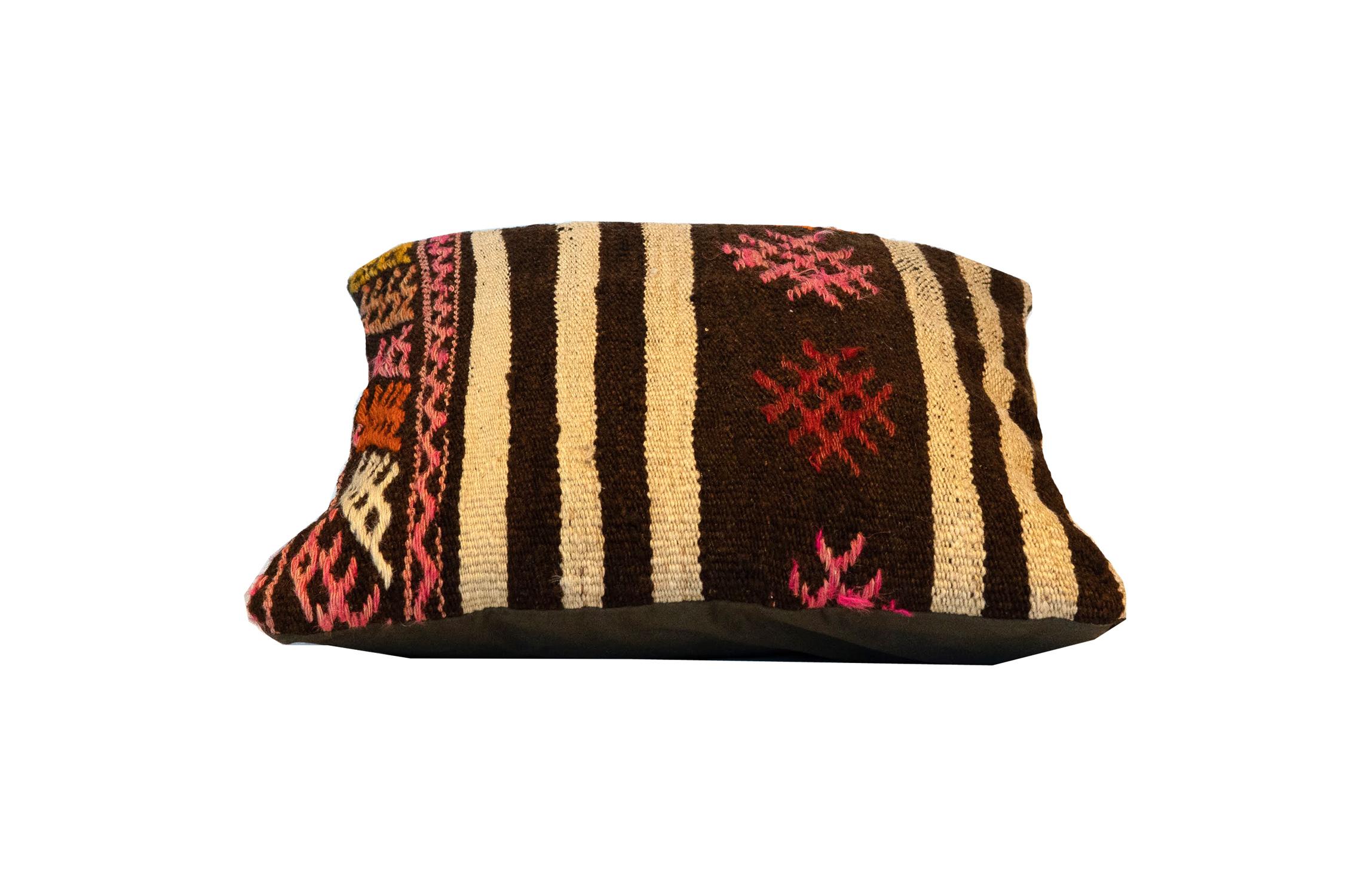 This beautiful handmade cushion has been handwoven with a fantastic, simple, yet effective design mixing simply striped and geometric motifs and patterns. The subtle black and cream stripe contrasts beautifully with the geometric details of pink,
