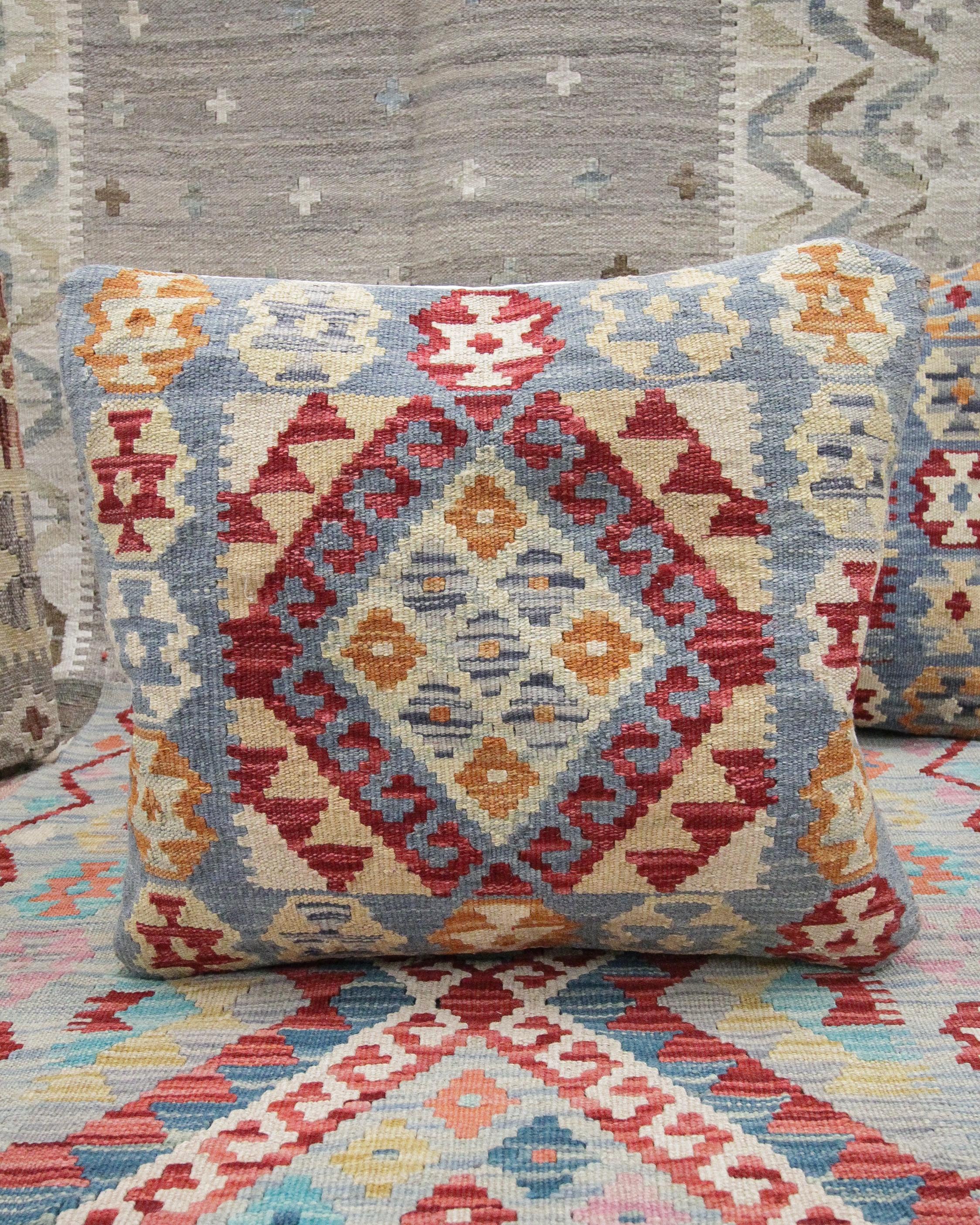 This new traditional kilim cushion cover is a handwoven piece constructed in the early 21st century. The design has been delicately woven by hand and features a symmetrical geometric pattern that is sure to stand out on any sofa or armchair! This