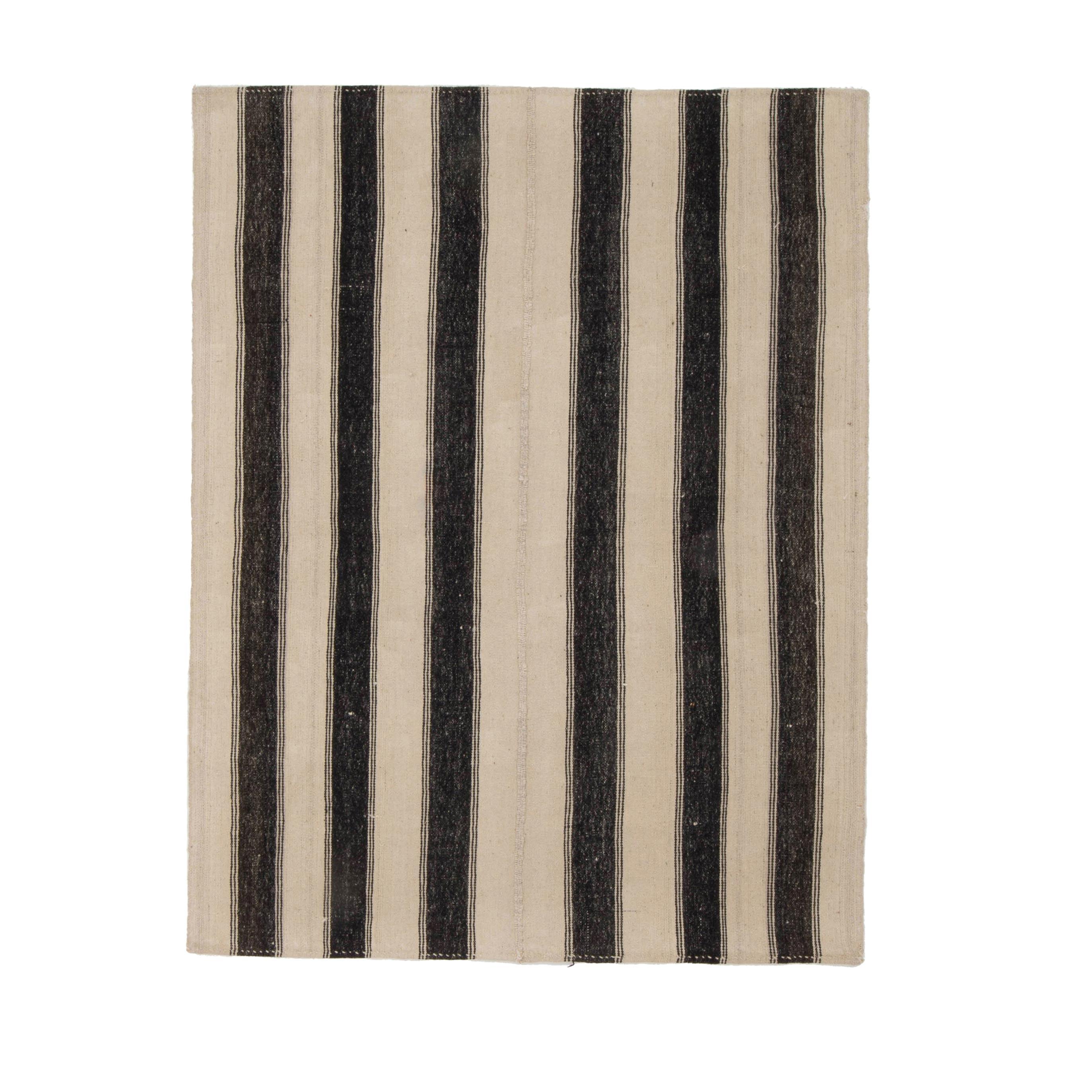 This is a pure wool small kilim woven with un-dyed wool from Central Anatolia Turkey.

These simple weavings are usually done for home use and bears all the characteristics of the area.
 