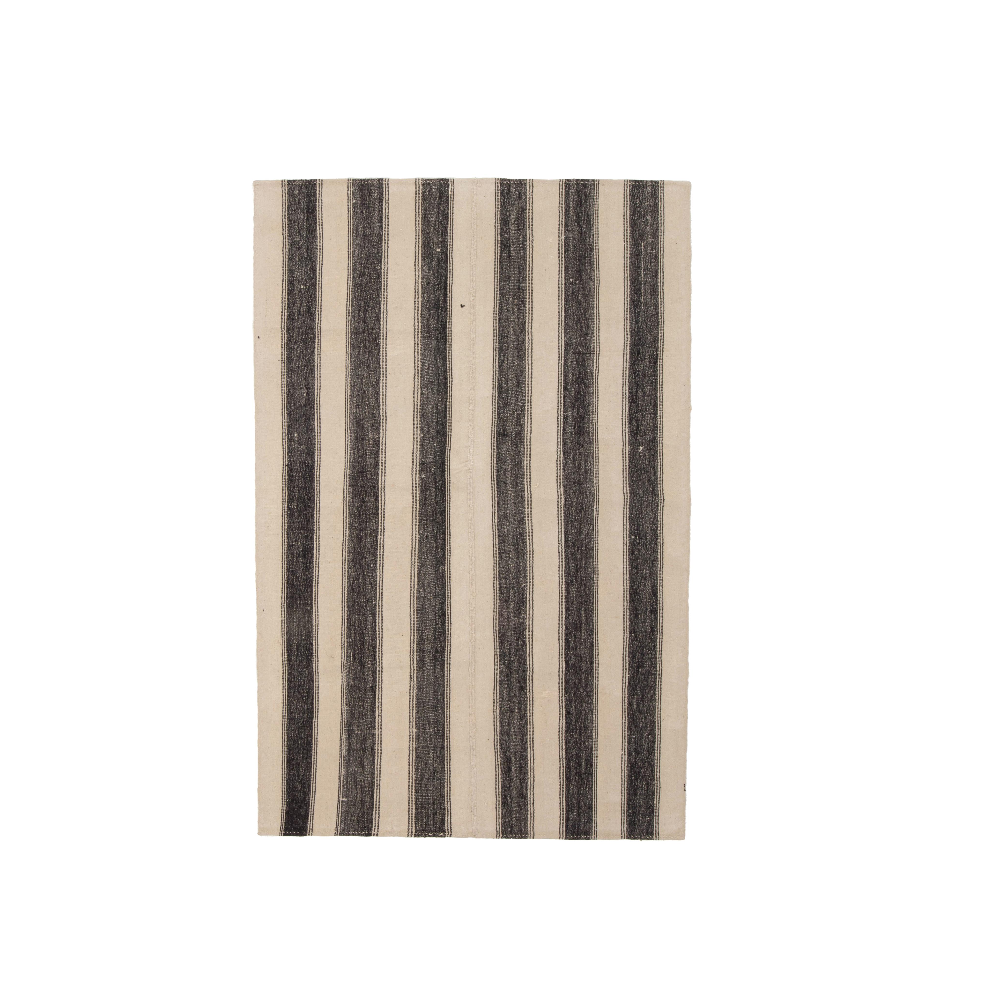 This is a pure wool small kilim woven with un-dyed wool from Central Anatolia Turkey.

These simple weavings are usually done for home use and bears all the characteristics of the area.



