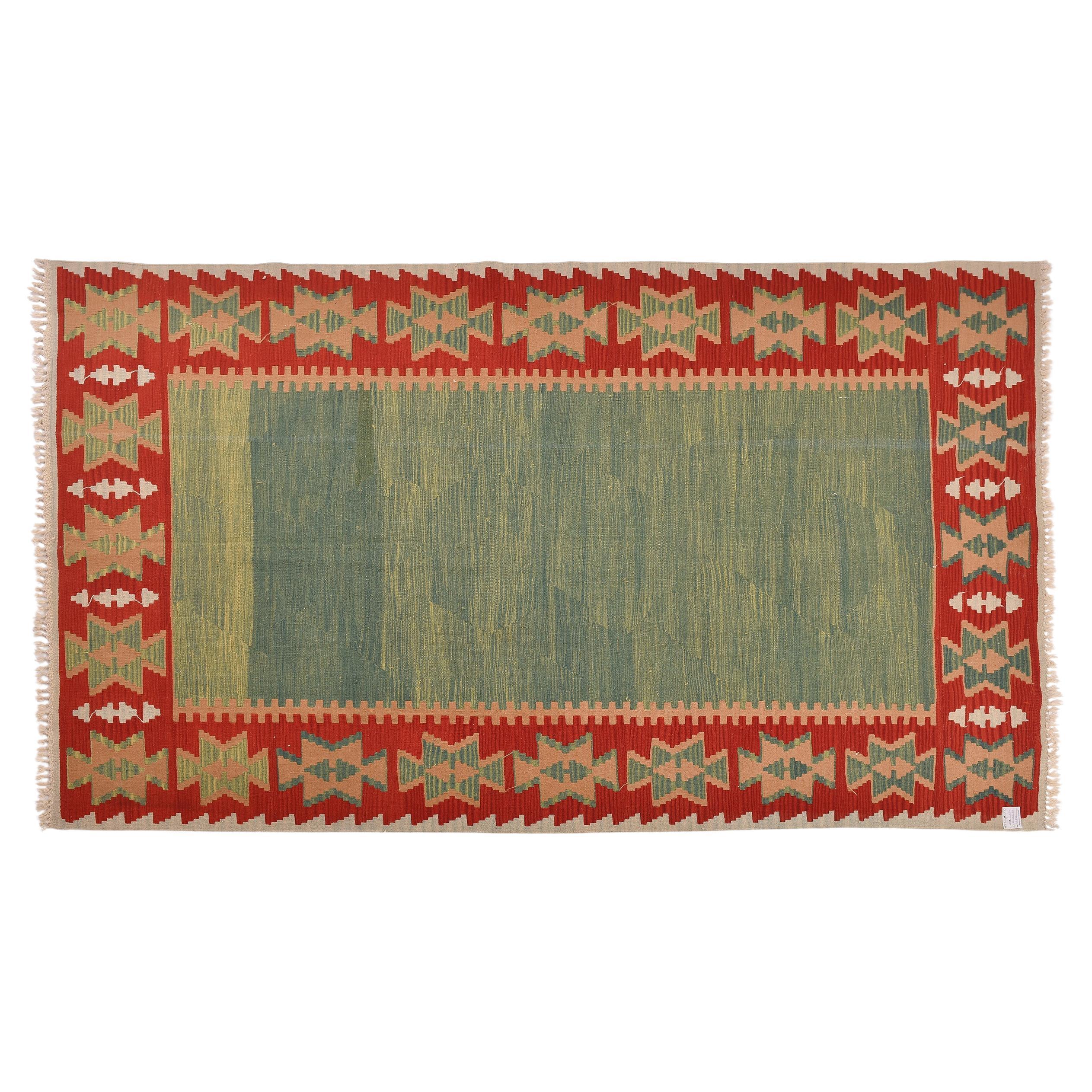 nr. 1341 - Vintage Turkish kilim KONYA, with an unusual beautiful green enclosed in a red frame.
Konya is one of the most famous towns in the Middle East.
Good size for living room.