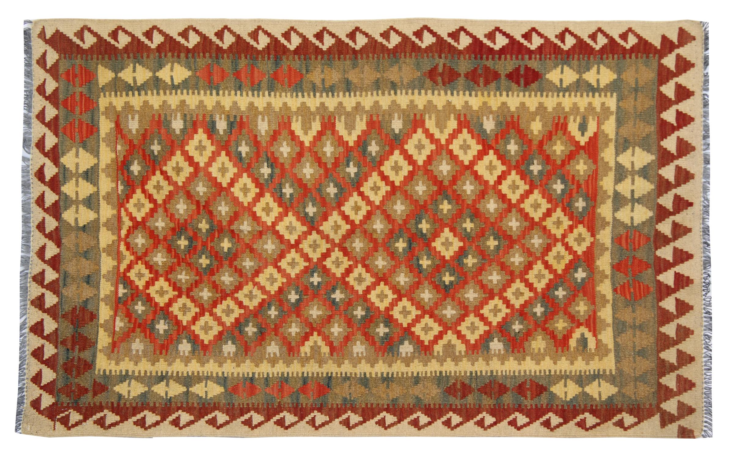 This truly unique area rug features a bright colour palette including yellow, orange, brown and accents of green. This piece has been woven with a geometric pattern of diamond motifs. Finished with a highly detailed layered border. Woven with the