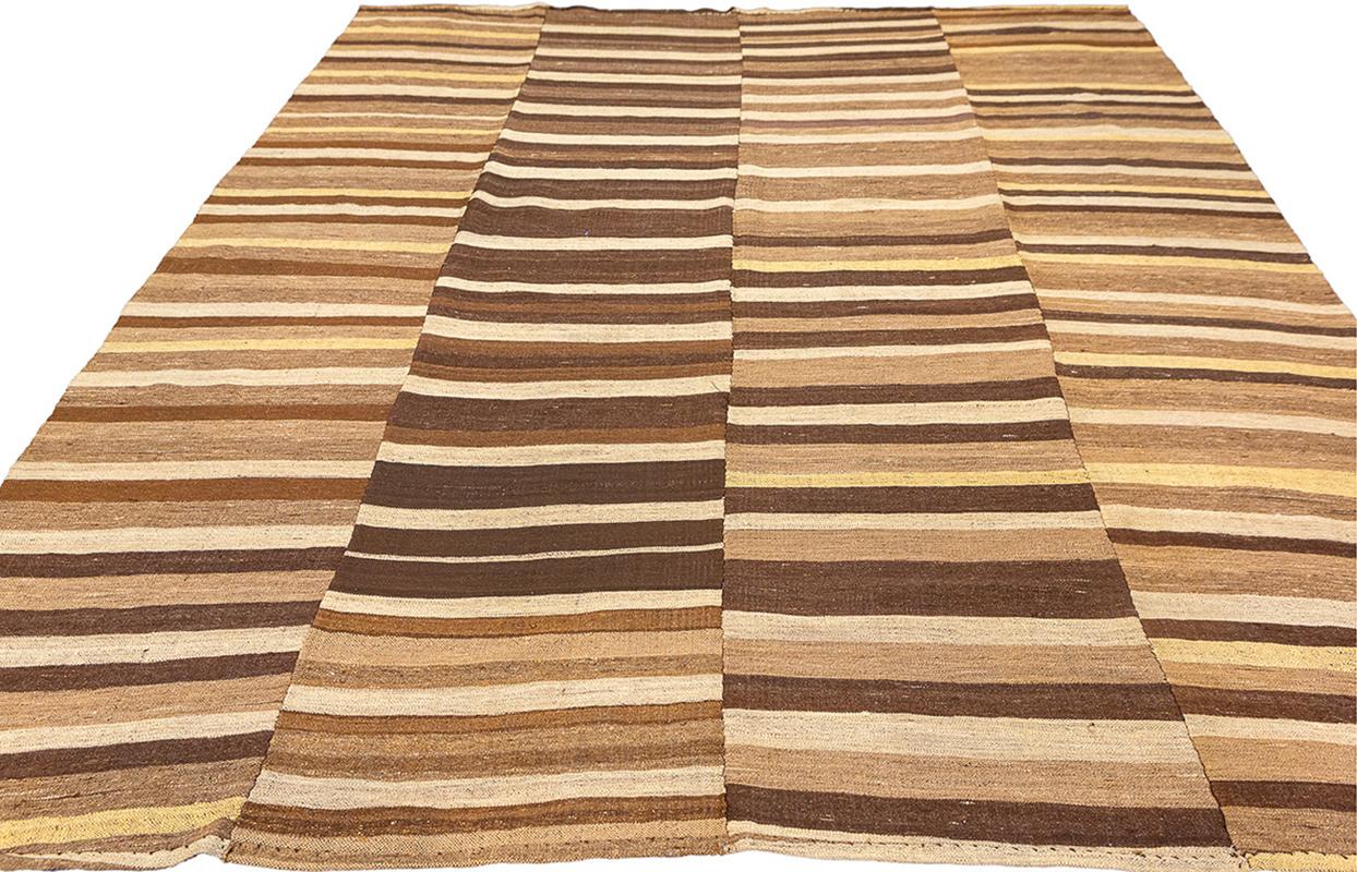 Rug & Kilim Design/One rayé dans les tons naturels
Cet authentique tapis Kilim vintage (240 × 206 cm) est un remarquable exemple d'artisanat traditionnel. Il présente un remarquable motif rayé dans un mélange harmonieux de tons naturels, dont