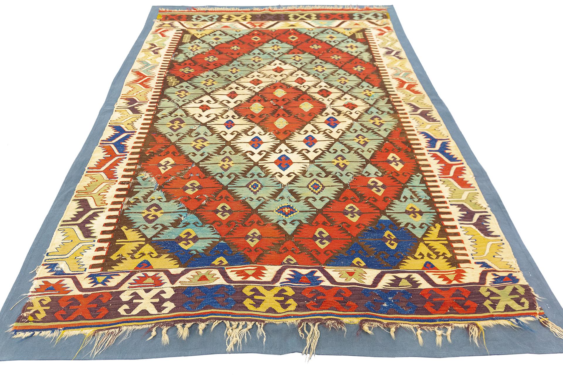 This Antique Turkish Aydin Kilim, with its dimensions of approximately 202 x 130 cm, is a vibrant example of traditional Anatolian artistry. Known for their striking geometric patterns and rich color schemes, Aydin Kilims embody the essence of