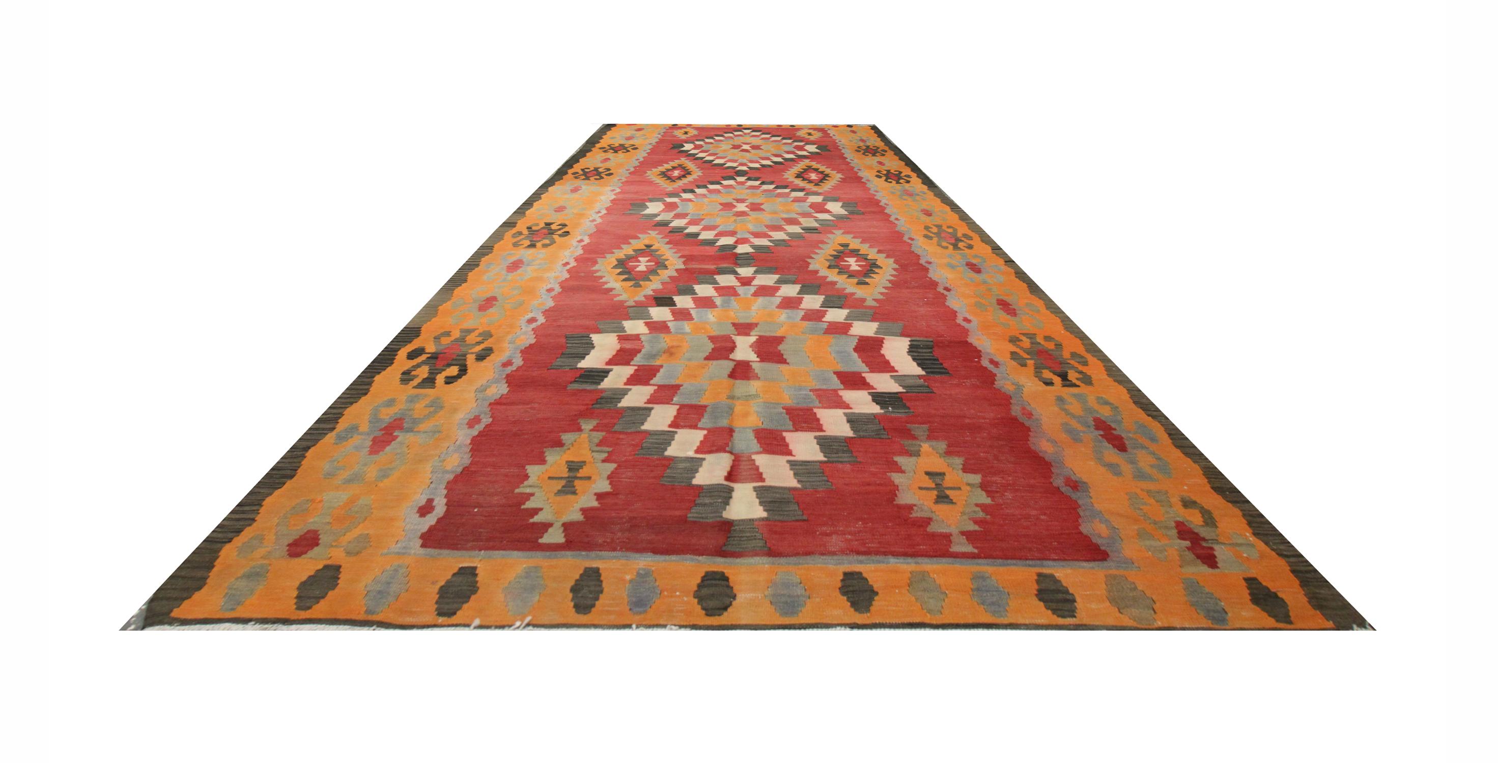 The rich tones in this colourful rug will complement your home's interior. The deep red background helps the orange, grey and blue tones to pop in this geometric design. Featuring a bold trio of geometric medallions with a highly decorative