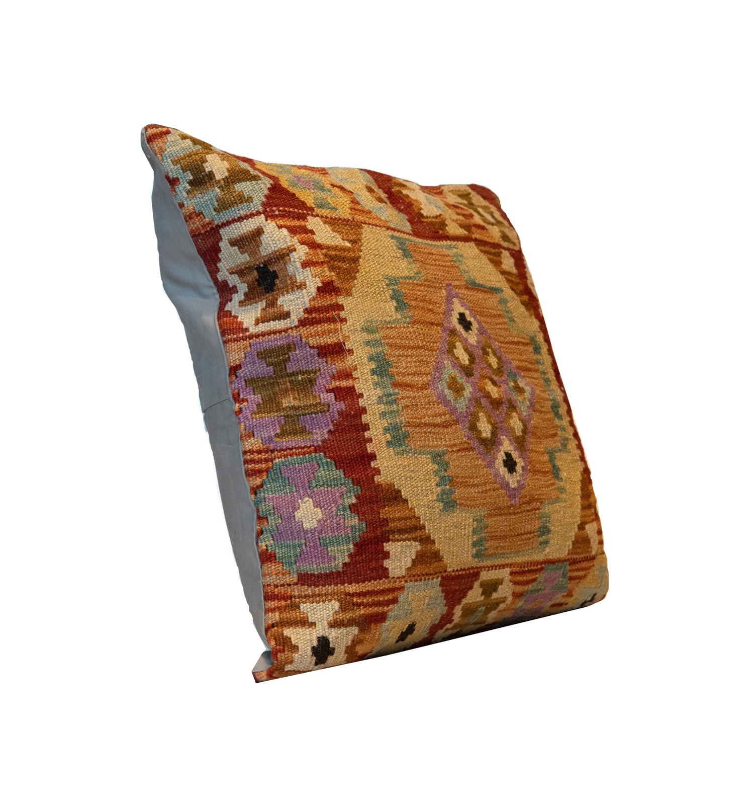 This truly unique geometric cushion cover is a handwoven kilim cushion cover woven in Afghanistan in the late 20th century/ early 21st century. Woven with an elegant geometric design with a subtle colour palette of brown, purple cream and blue. Both