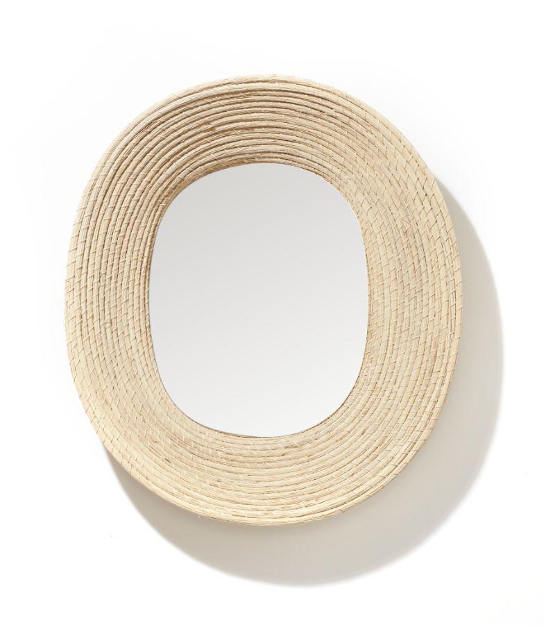 Killa oval shaped mirror by Pauline Deltour
Materials: galvanized and powder-coated tubular steel frame. Fibers from Iraca palm leaves fiber.
Technique: hand-woven with natural fibers in Colombia. Natural dyed. 
Dimensions: W 46.6 x H 53.3 cm