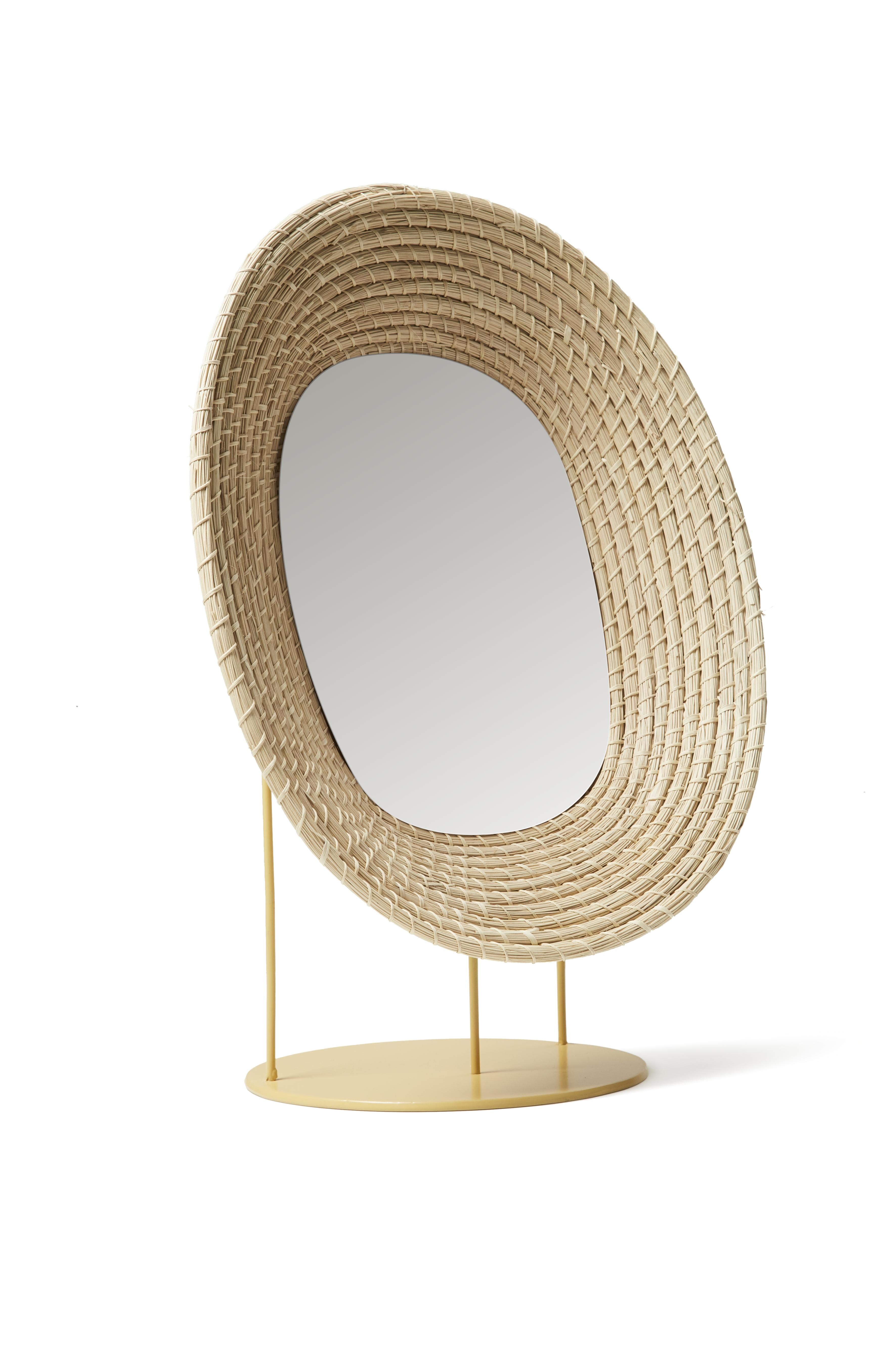 Killa standing mirror by Pauline Deltour
Materials: Galvanized and powder-coated tubular steel frame. Fibers from Iraca palm leaves fiber.
Technique: Hand-woven with natural fibers in Colombia. Natural dyed. 
Dimensions: W 34 x H 46 cm