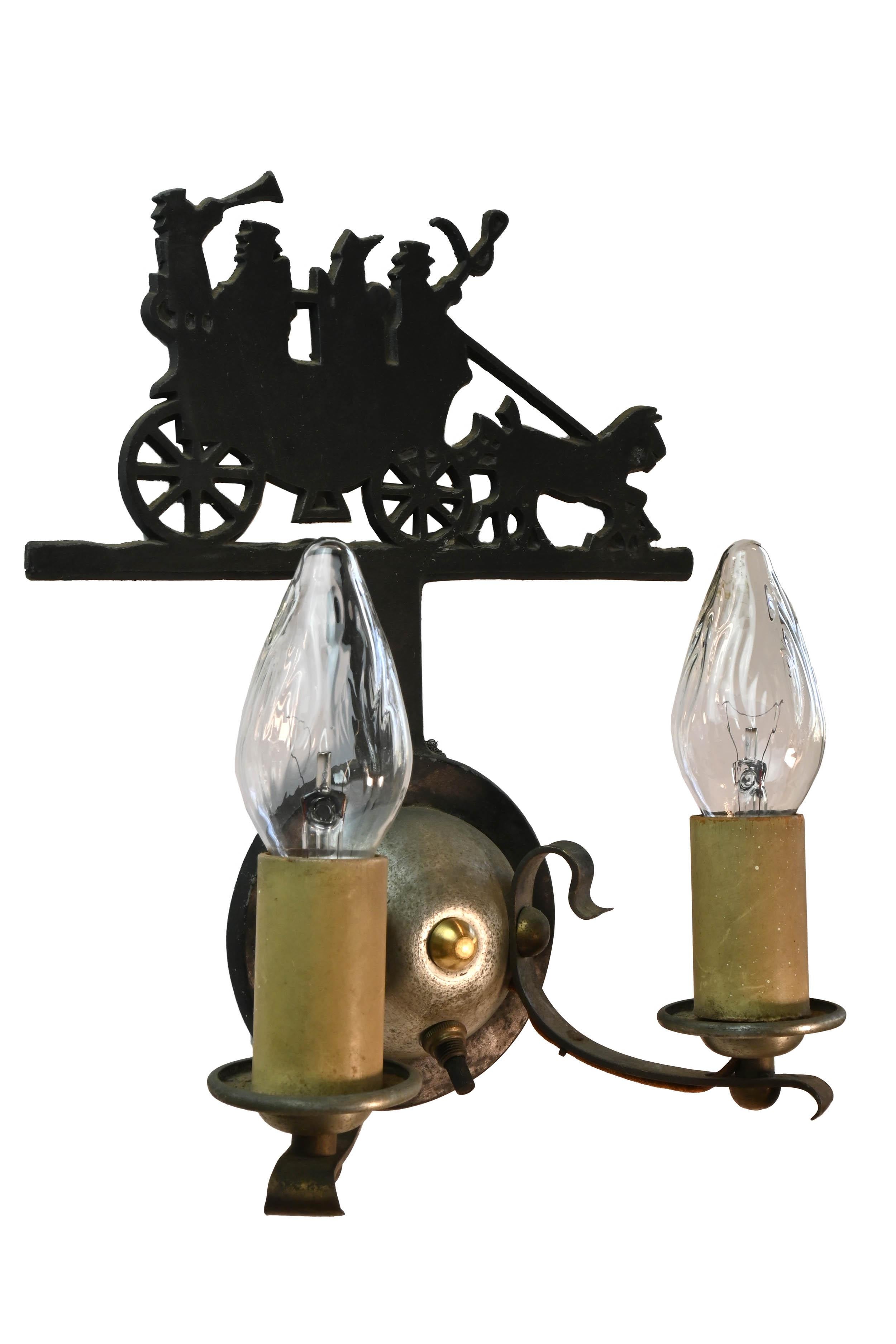 Two candle sconce illuminating a cheerful horse drawn carriage scene. 

  

circa 1920s
Condition: Age consistent “Very Good”
Material: Cast iron, cast and spun aluminum 
Finish: Original finish
Country of origin: USA
Illumination: two