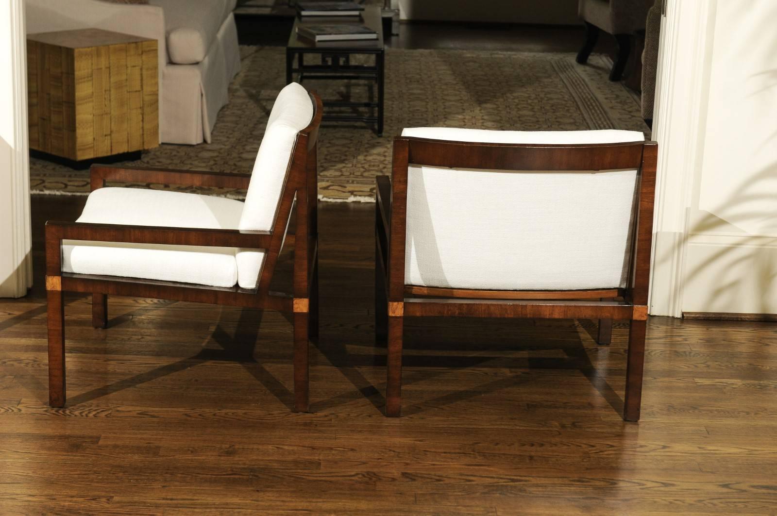 A jaw-dropping restored pair of low-slung walnut loungers, circa 1970. Heavy as lead ash frame exquisitely veneered in walnut; burl accents mark the legs. Unbelievable design and quality. Expert custom upholstery in a stunning neutral Romo crepe