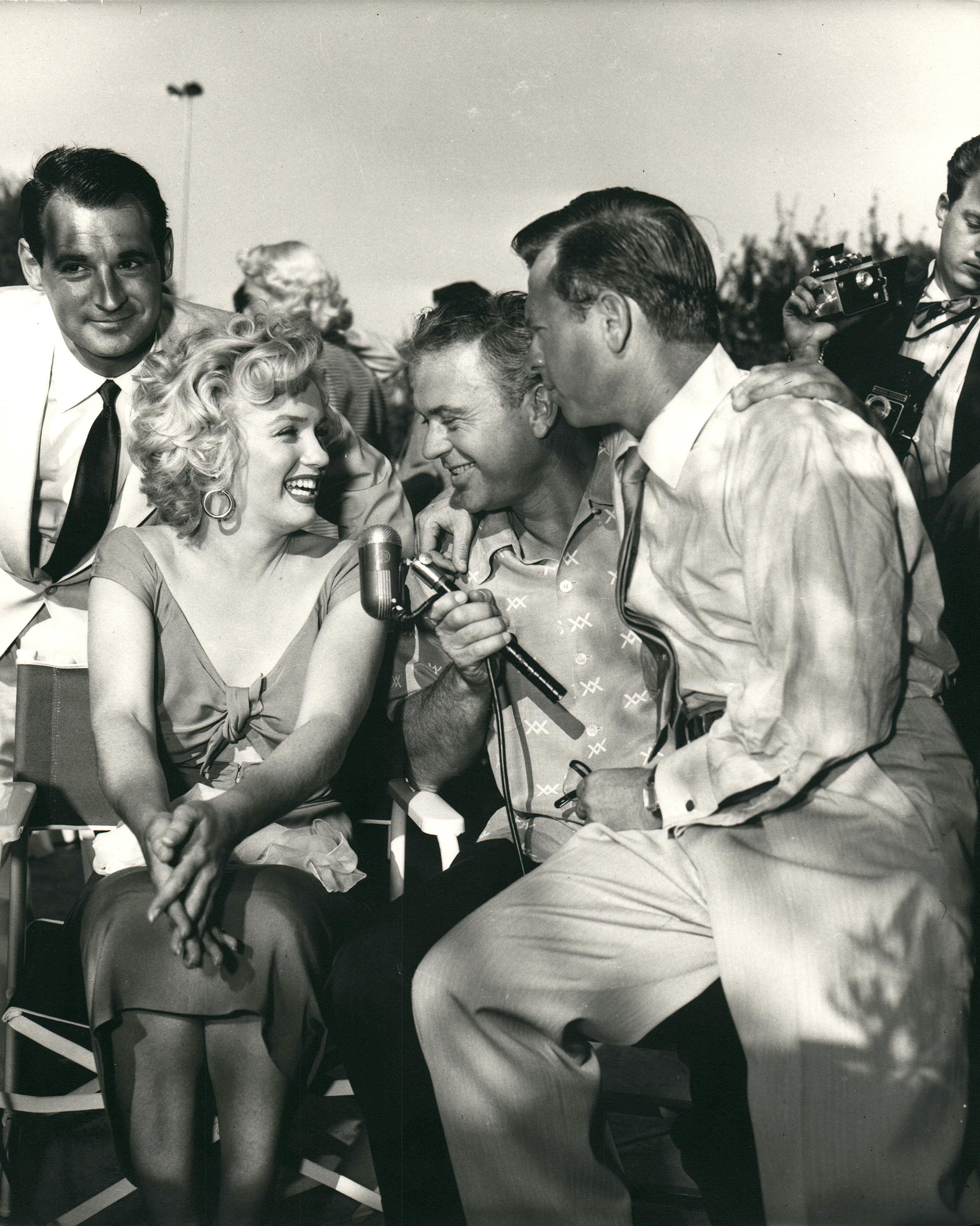 Kim Goodwin Portrait Photograph - Marilyn Monroe Speaking in Microphone Outdoors Vintage Press Print