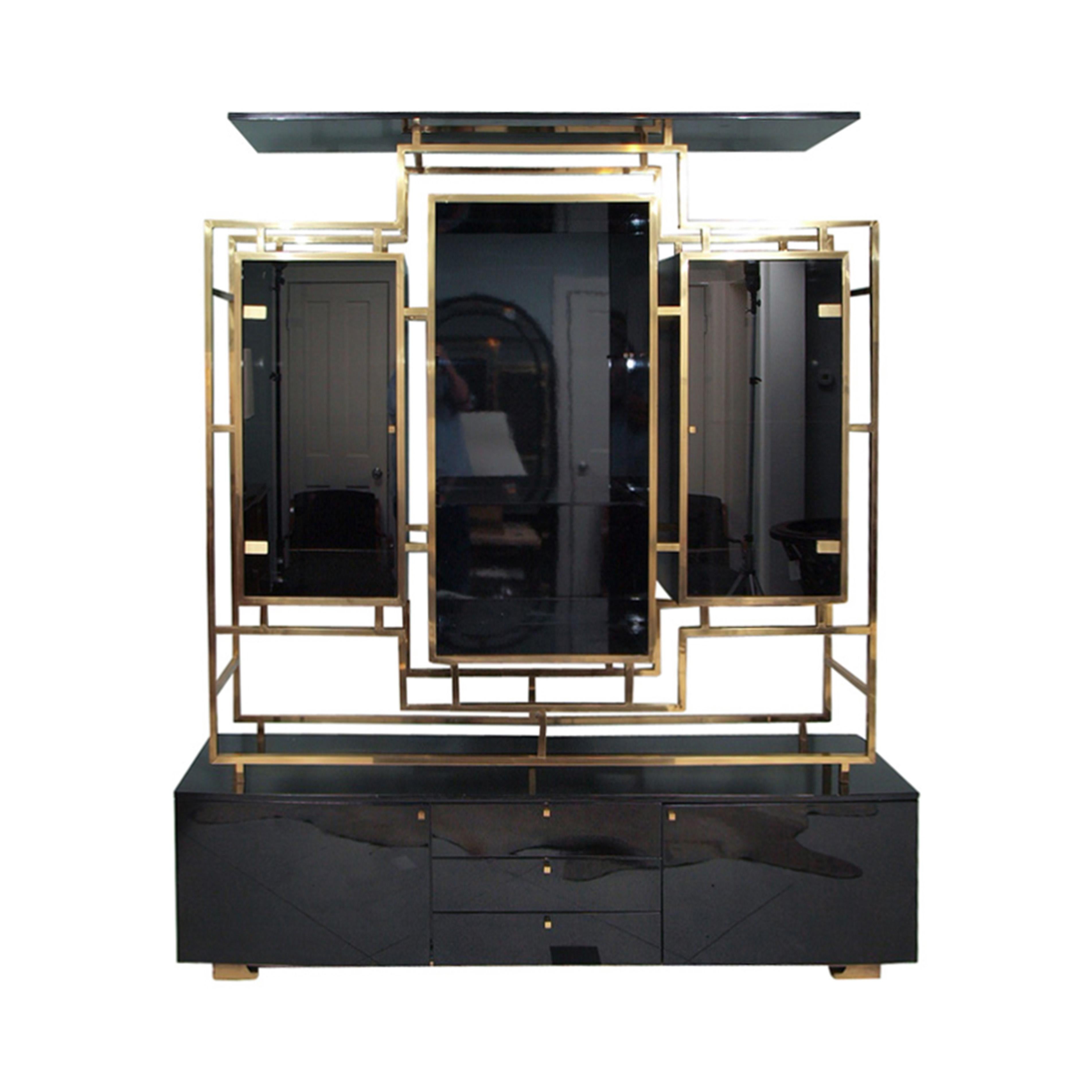 Monumental two-piece 1970s impressive enclosed brass display cabinet/sideboard by Kim Moltzer, often attributed to Guy Lefevre. Top tier structure in square brass tubing, black lacquered wood with doors and shelves in smoked glass. Bottom tier